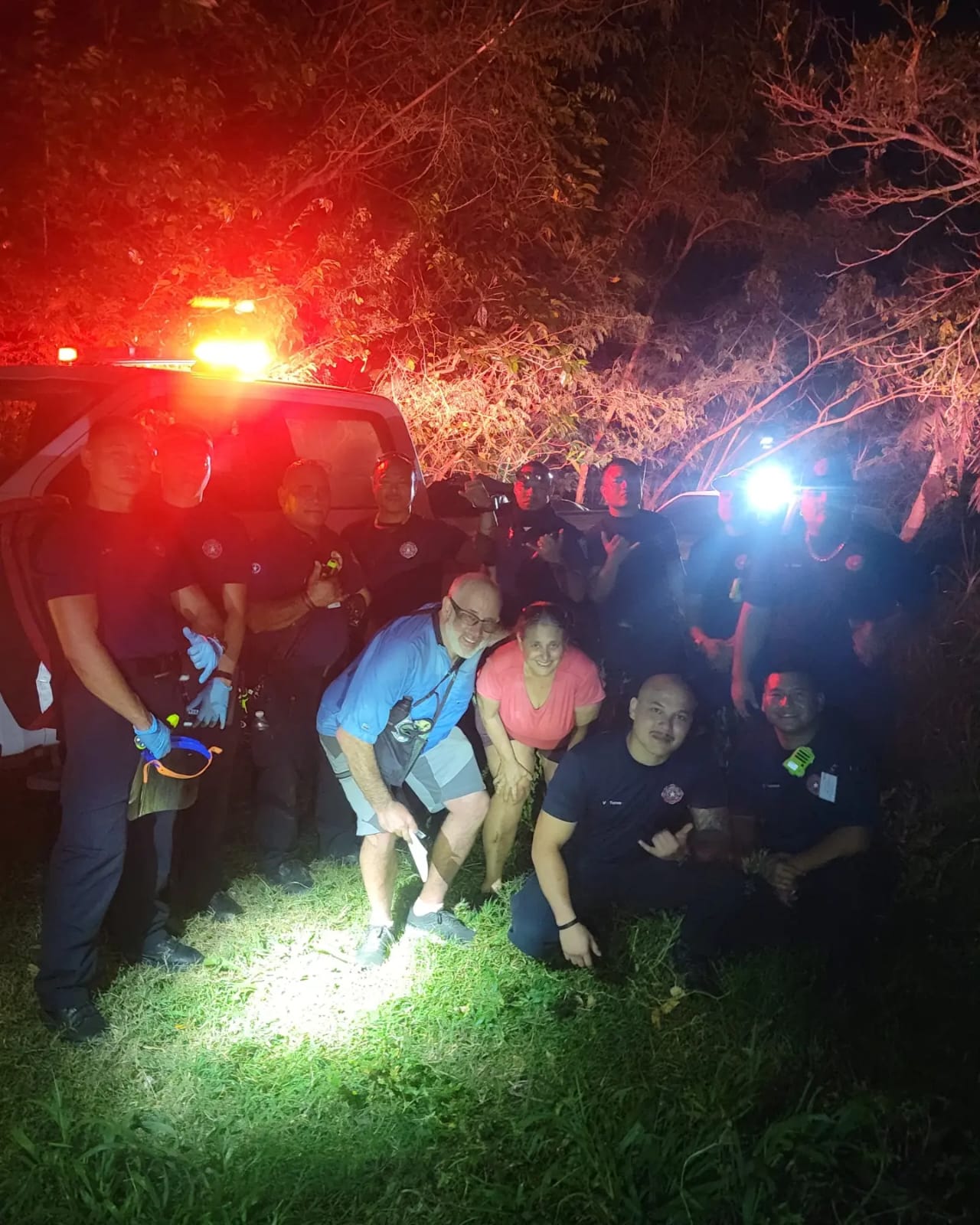 The relieved hikers pose for a photo with the fire department personnel who found them in Marpi Tuesday evening.