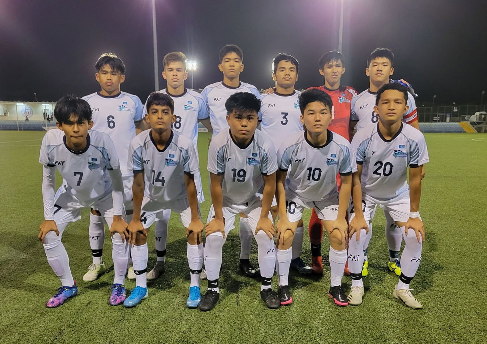 The NMI Men's U20 team members pose for a photo before their friendly match against Guam at the Guam Football Association National Training Center in Dededo.