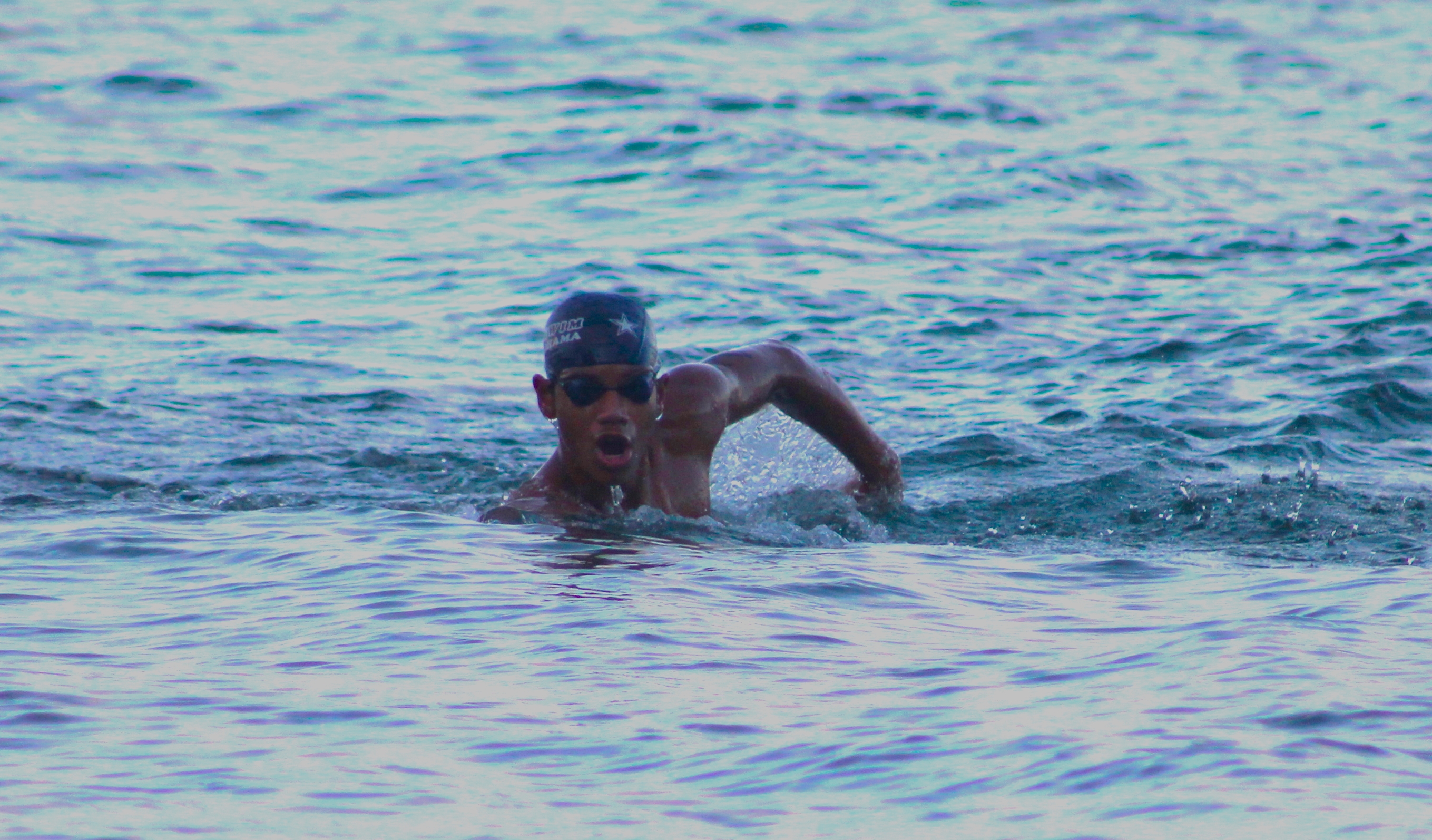 Isaiah Aleksenko takes a breath during the swimming portion of TRAC's 7th Aquathon on Saturday morning.