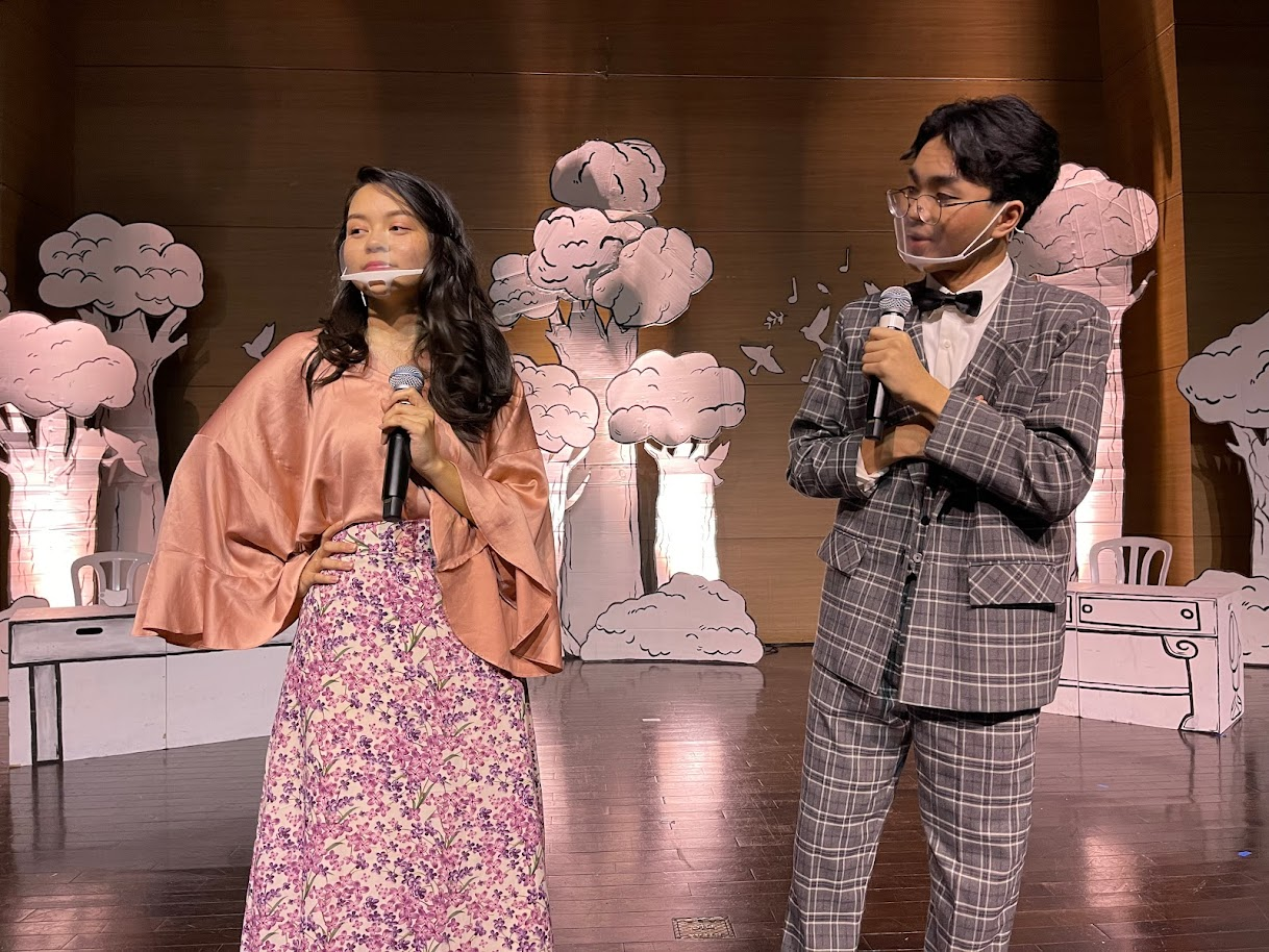 Max Detweiler, played by Brent Ortizo and Elsa Schraeder, played by Malina Tenorio, brainstorm on how she can court Captain von Trapp into marriage.