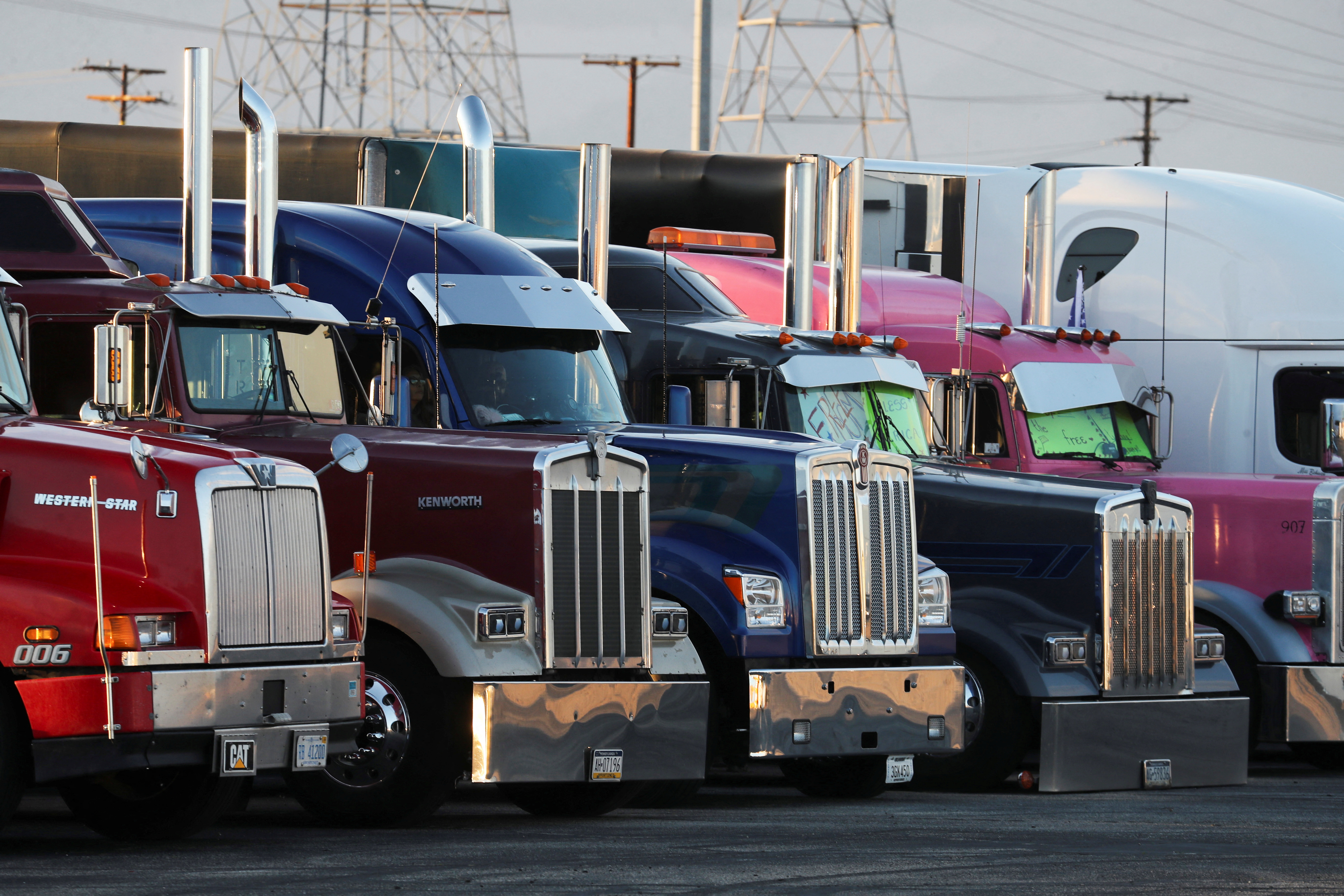 Truckers and their supporters start to gather before a convoy leaves the following morning bound for the nation's capital to protest against coronavirus disease vaccine mandates, in Adelanto, California, Feb. 22, 2022.