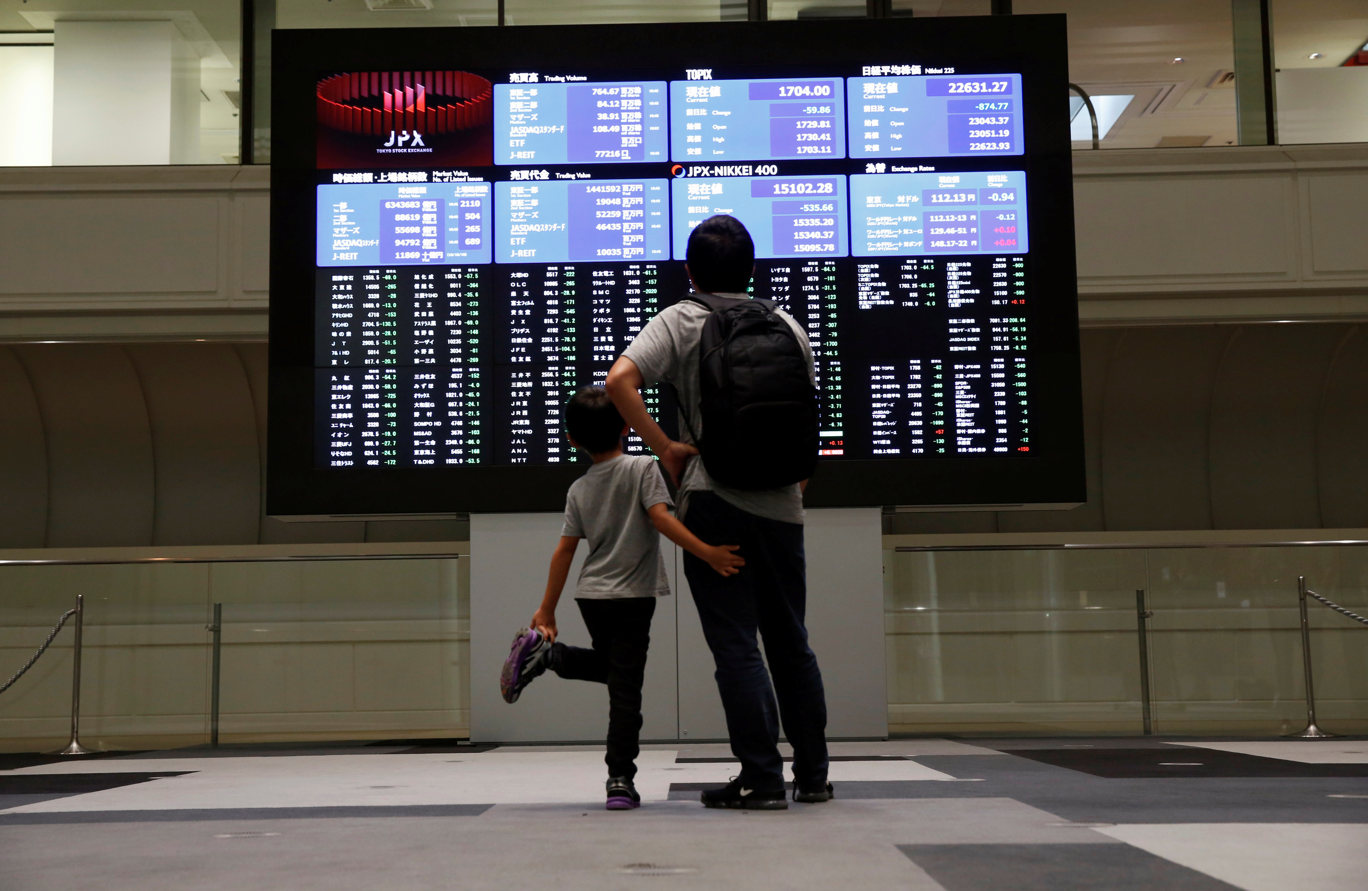 Visitors look at a stock quotation board at Tokyo Stock Exchange in Tokyo Japan, Oct. 11, 2018.