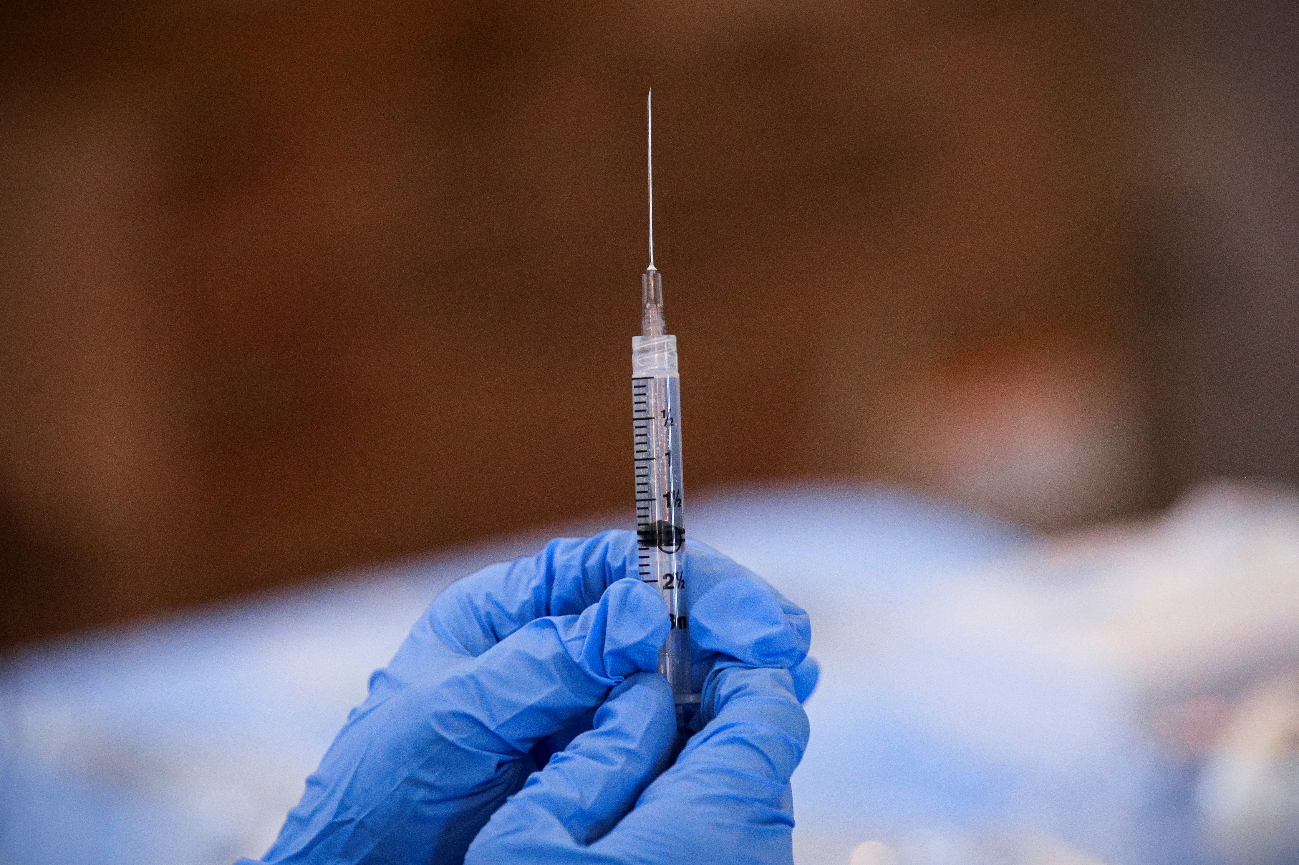 A syringe is filled with a dose of Pfizer's coronavirus disease vaccine at a pop-up community vaccination center at the Gateway World Christian Center in Valley Stream, New York, Feb. 23, 2021.