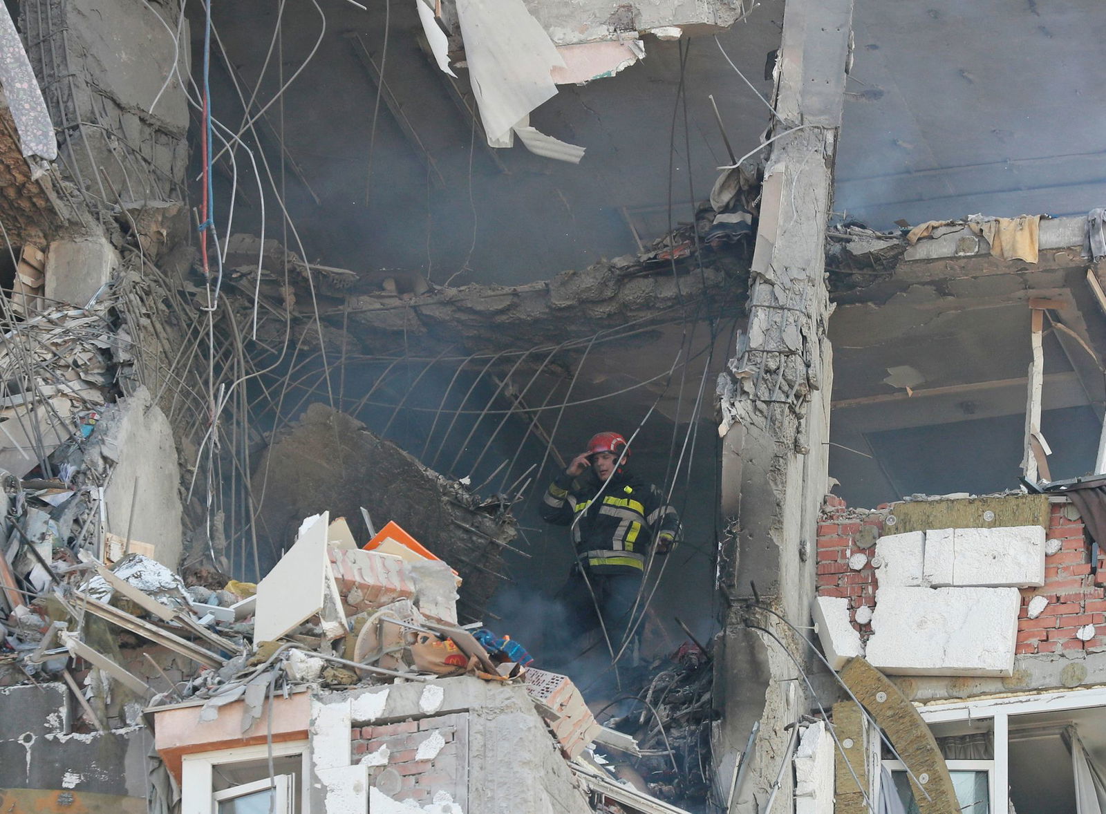 A firefighter works inside an apartment building damaged by recent shelling in Kyiv, Ukraine Feb. 26, 2022. 