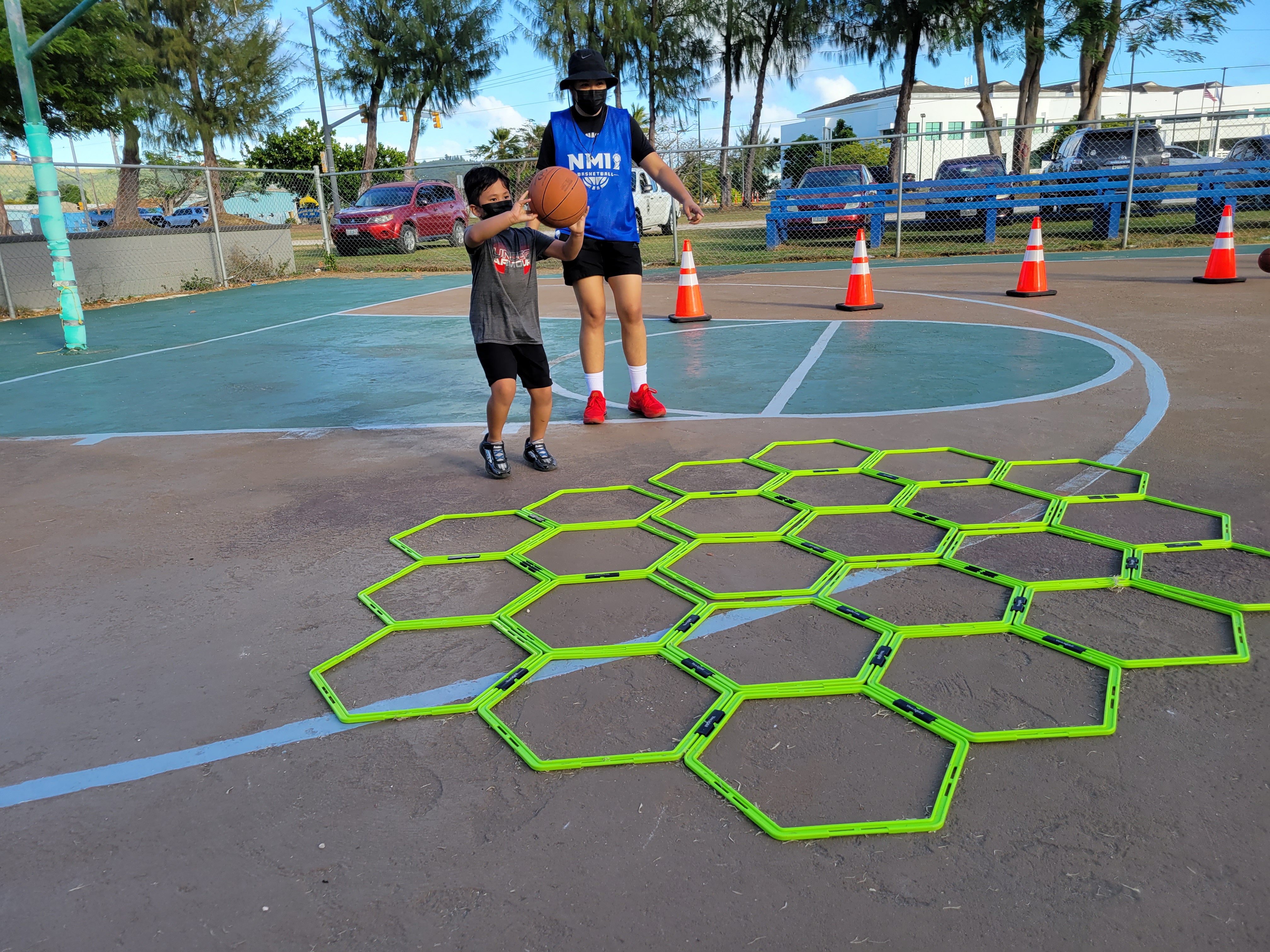 Christian Sanchez makes a pass to a “Bola” volunteer before working his way out of the obstacle course during a session at the Civic Center Basketball Court on Saturday.