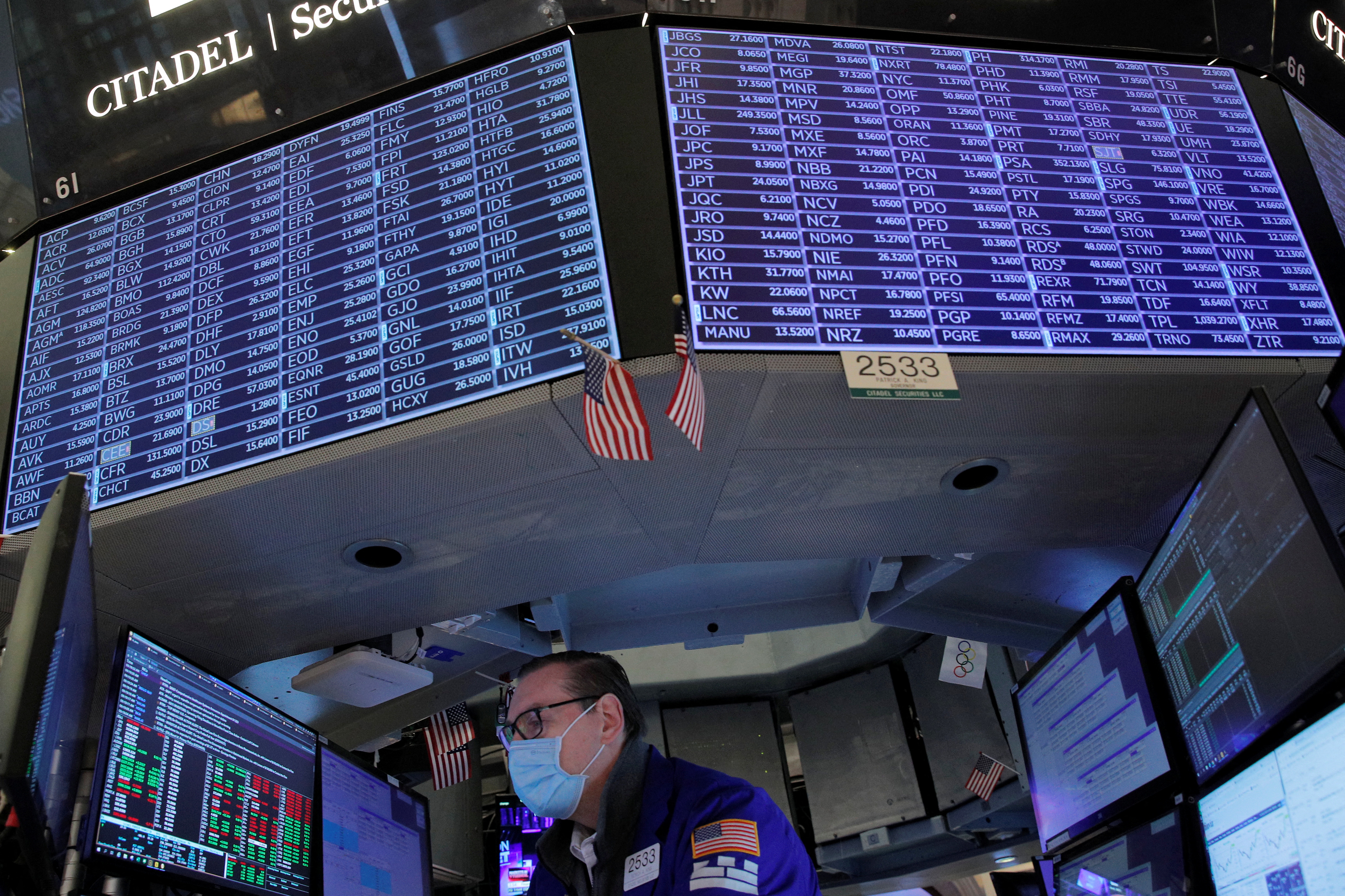 A specialist trader works inside a booth on the floor of the New York Stock Exchange in New York City, Jan. 25, 2022.
