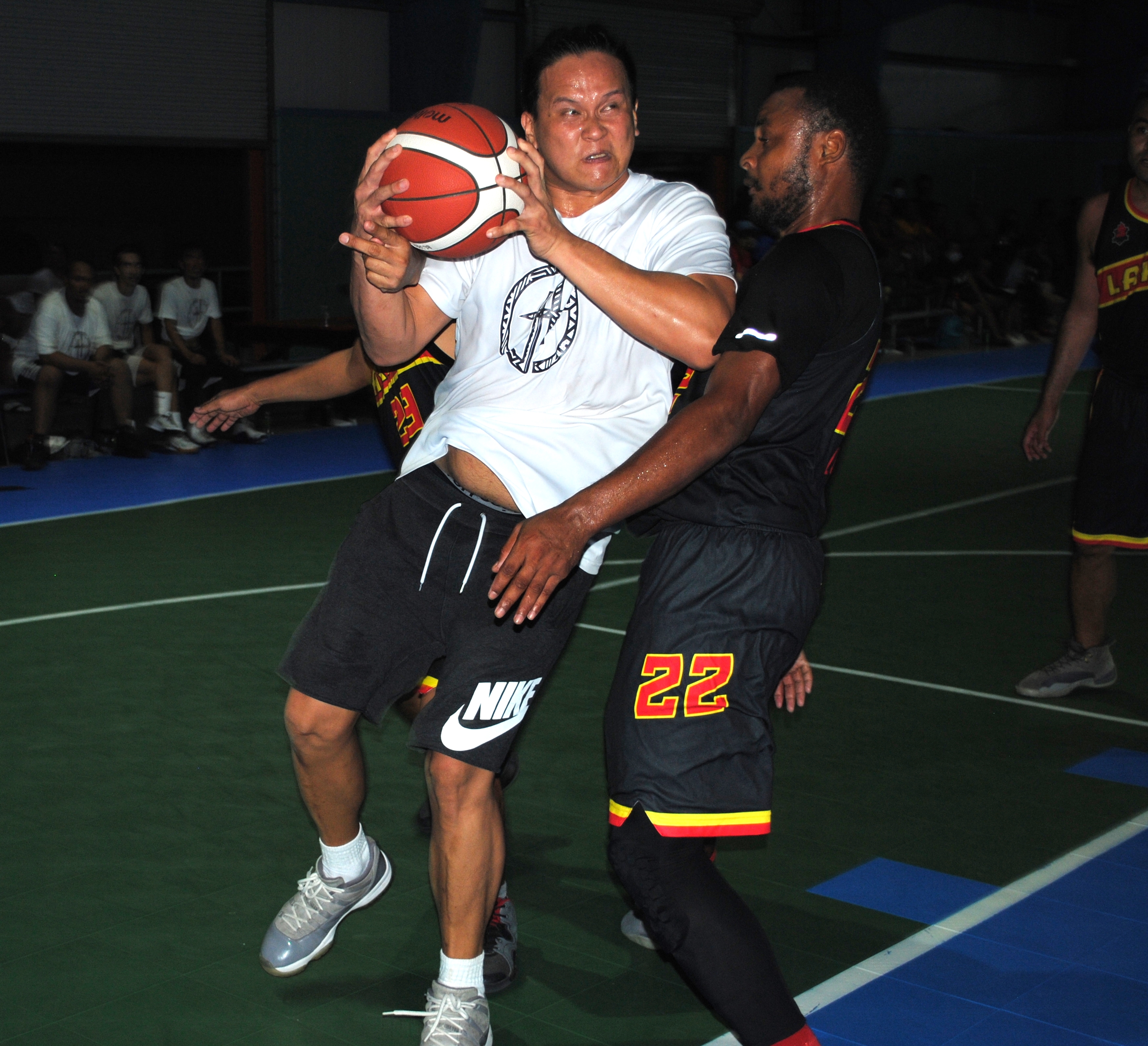 The Game's Arellano makes contact as he posts inside the paint during an Open Division game of the Saipan Centennial Lions Club Basketball League Saturday at the TSL Sports Complex.