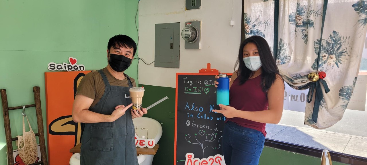 Ice 2 C U owner Pei “Perry” Li, left, and Green 2 Go Saipan  founder and chief executive officer Soarin Oh, right, pose for a photo during the launch of an environmental campaign on Thursday.