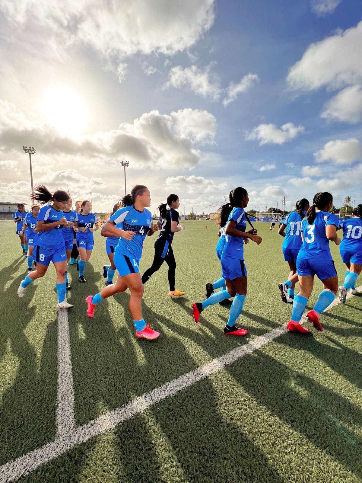 The NMI Women's U18 team warm up before their friendly match against their Guam counterparts at the Guam Football Association National Training Center in Dededo.