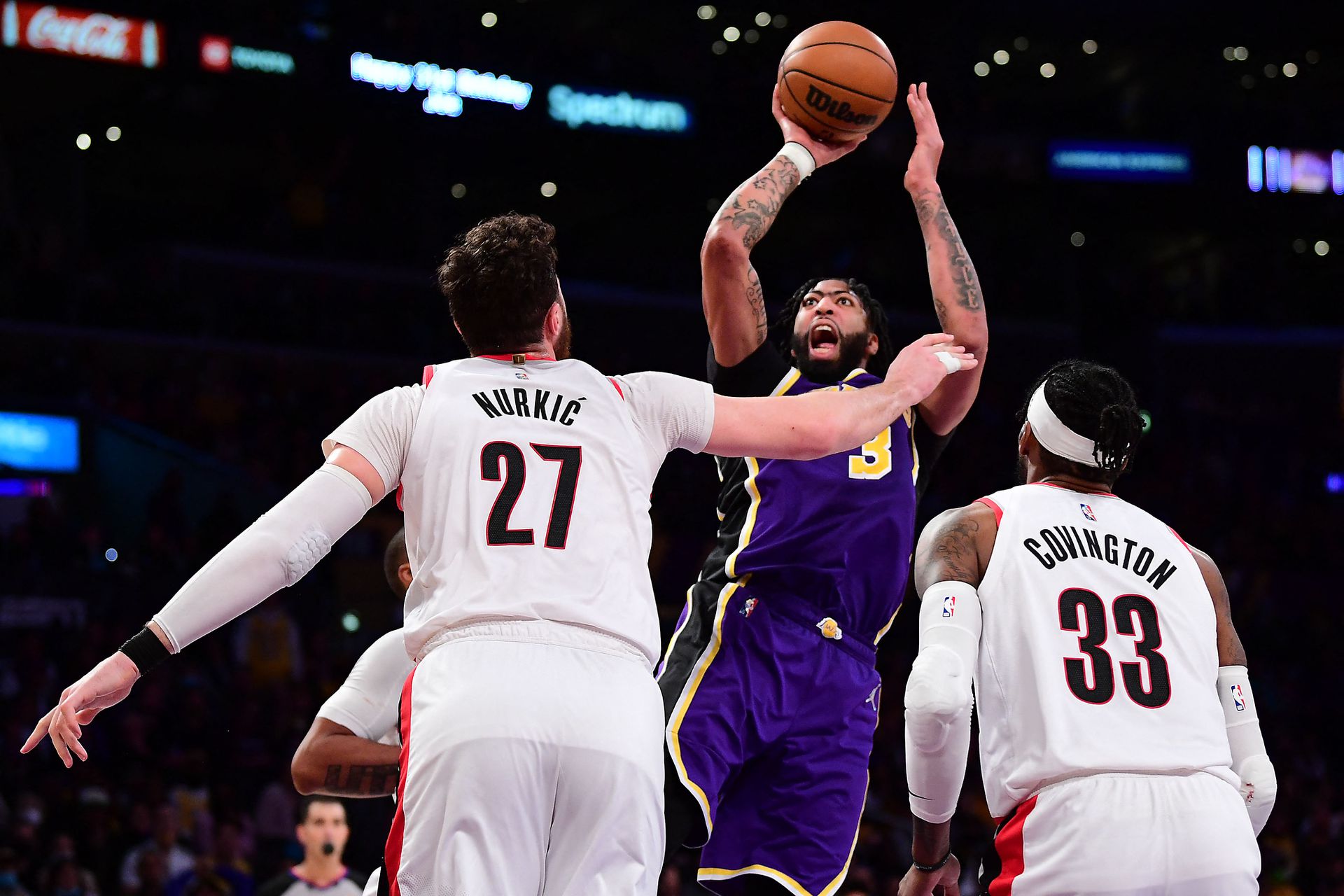 Los Angeles Lakers forward Anthony Davis (3) shoots against Portland Trail Blazers center Jusuf Nurkic (27) and forward Robert Covington (33) during the second half at Crypto.com Arena in Los Angeles, California on Feb. 2, 2022.