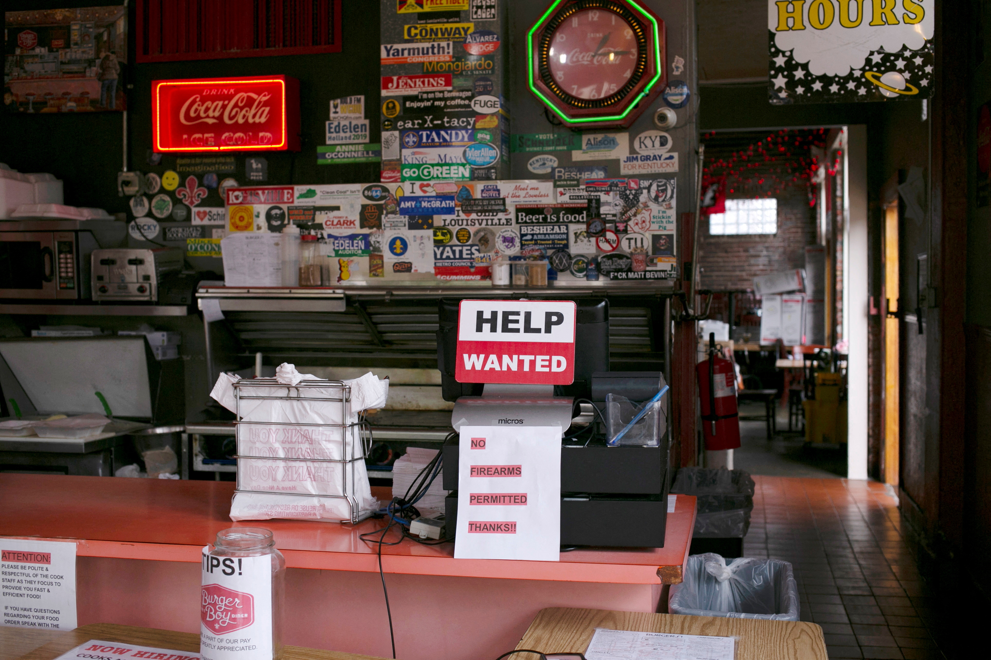A hiring sign is seen at the register of Burger Boy restaurant, as many restaurant businesses face staffing shortages in Louisville, Kentucky, June 7, 2021.  