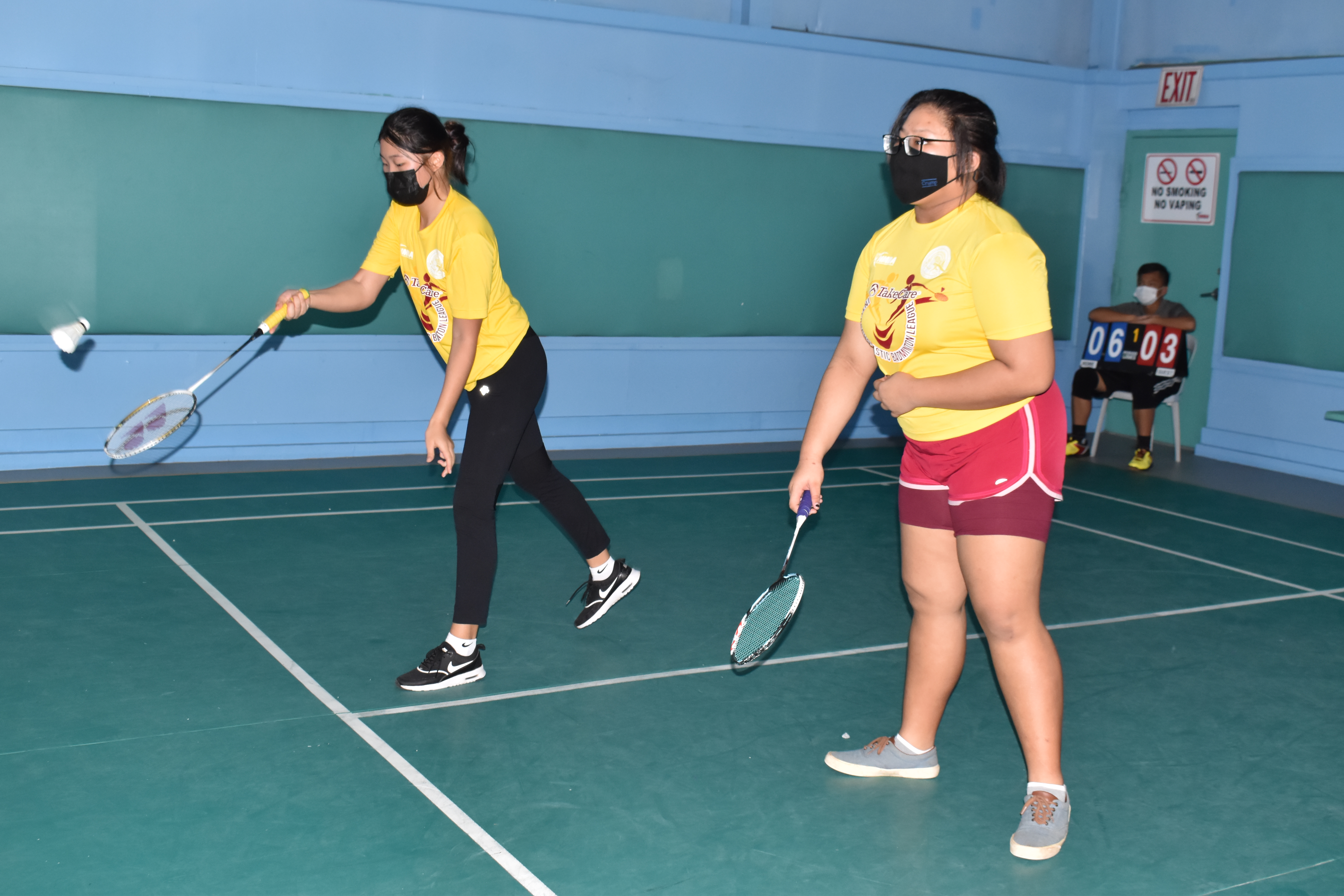 Hopwood 1's Teresa Ahn and Shemariah Hicaro play against FMS in the girls doubles division of the TakeCare Interscholastic Middle School Badminton League on Saturday at the TSL Sports Complex.