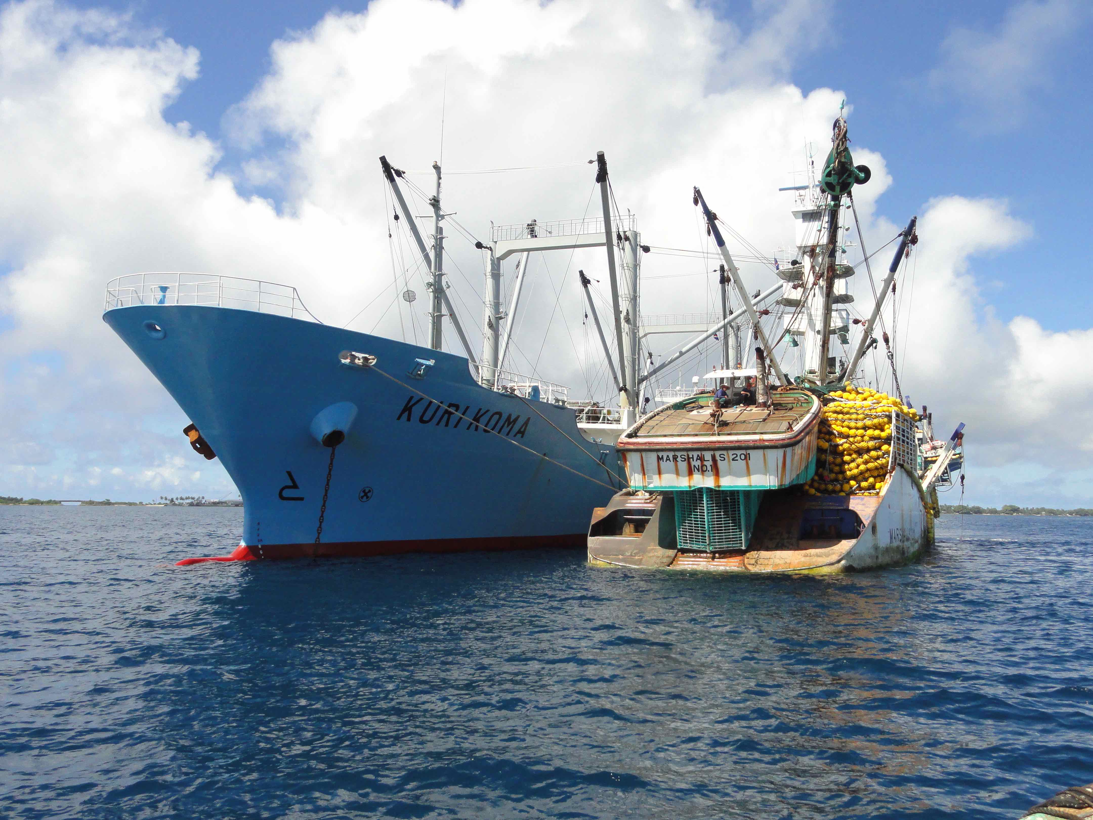 Marshalls 201 purse seiner, at right tied to a tuna transshipment carrier vessel, is one of several thousand ships globally that are registered in the Marshall Islands, which operates the world's third largest ship registry.