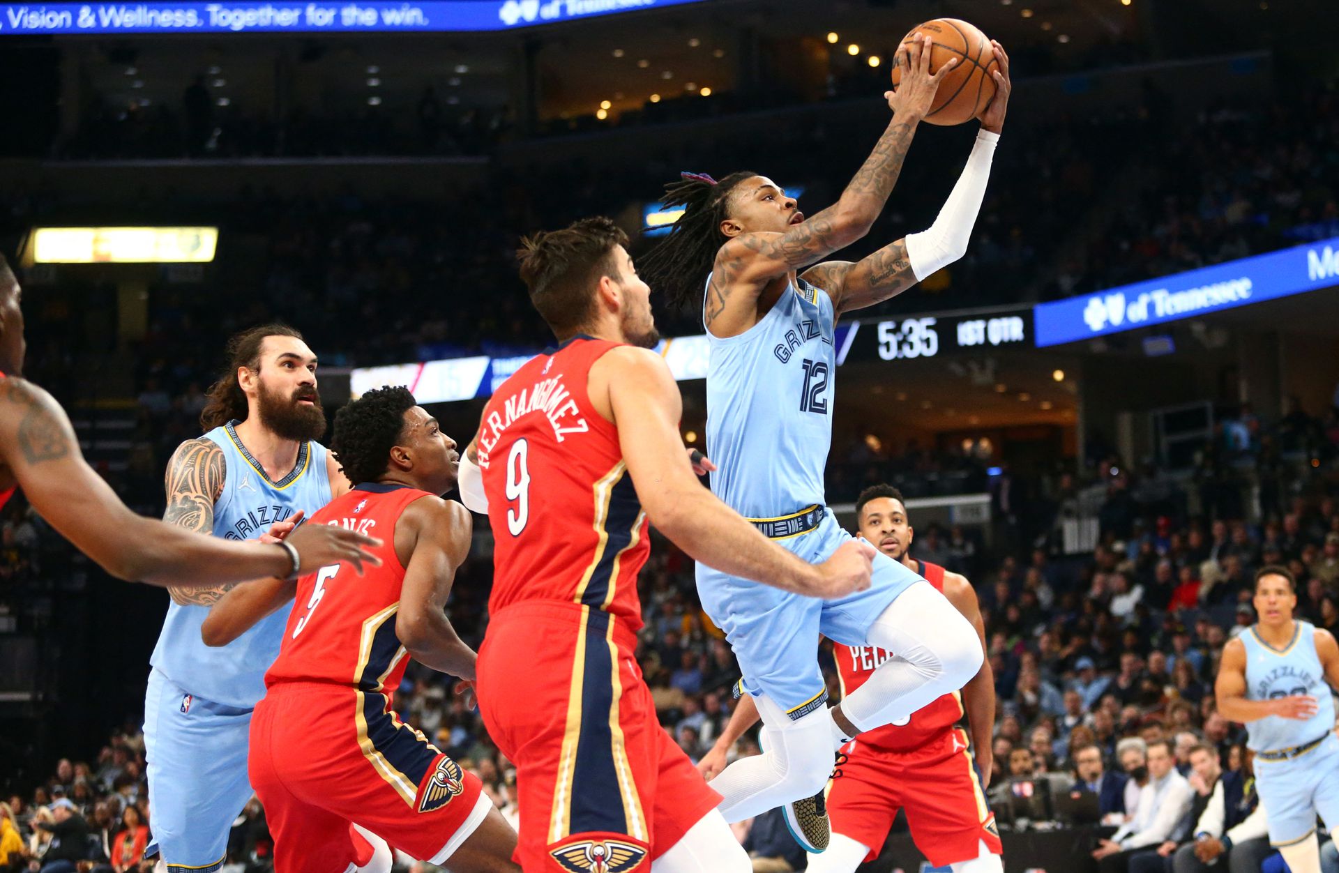 Memphis Grizzlies guard Ja Morant (12) drives to the basket as New Orleans Pelicans center-forward Willy Hernangomez (9) defends during the first half at FedExForum in Memphis, Tennessee on March 8, 2022.