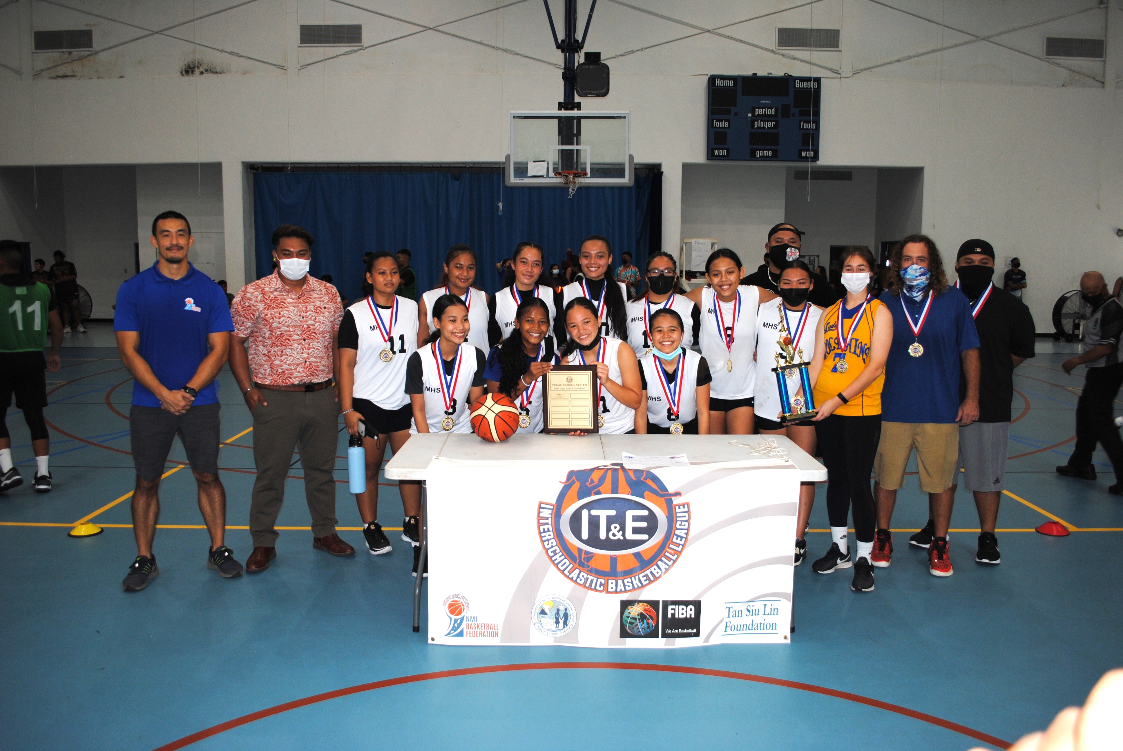 The Marianas High school Dolphins pose with the perpetual plaque after winning the IT&E Interscholastic Basketball League championship Saturday at the MHS gym.