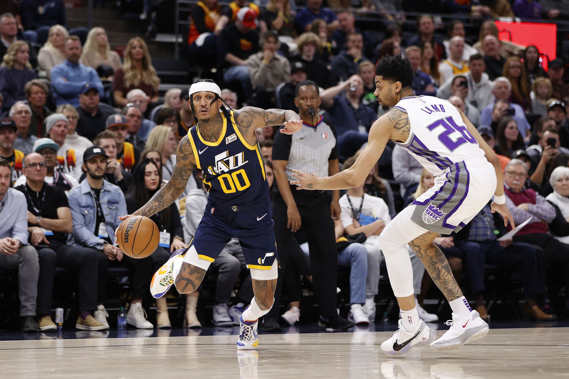 Utah Jazz guard Jordan Clarkson (00) looks to drive against Sacramento Kings guard Jeremy Lamb (26) in the fourth quarter at Vivint Arena in Salt Lake City, Utah on March 12, 2022.