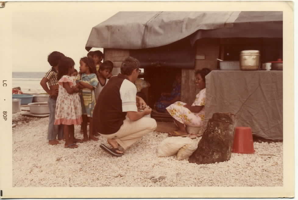 Joe Murphy, reporter, drew a crowd of children as he conducted an interview in Majuro in the late 1970s.