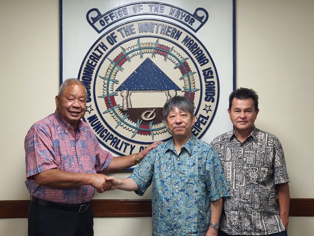 Saipan Mayor David M. Apatang, left, shakes hands with Japan’s new consul to the island, Ryoji Takagaki,  during a meeting at the mayor’s office on March 22, 2022. Also in the photo is the mayor’s special assistant, Henry Hofschneider.