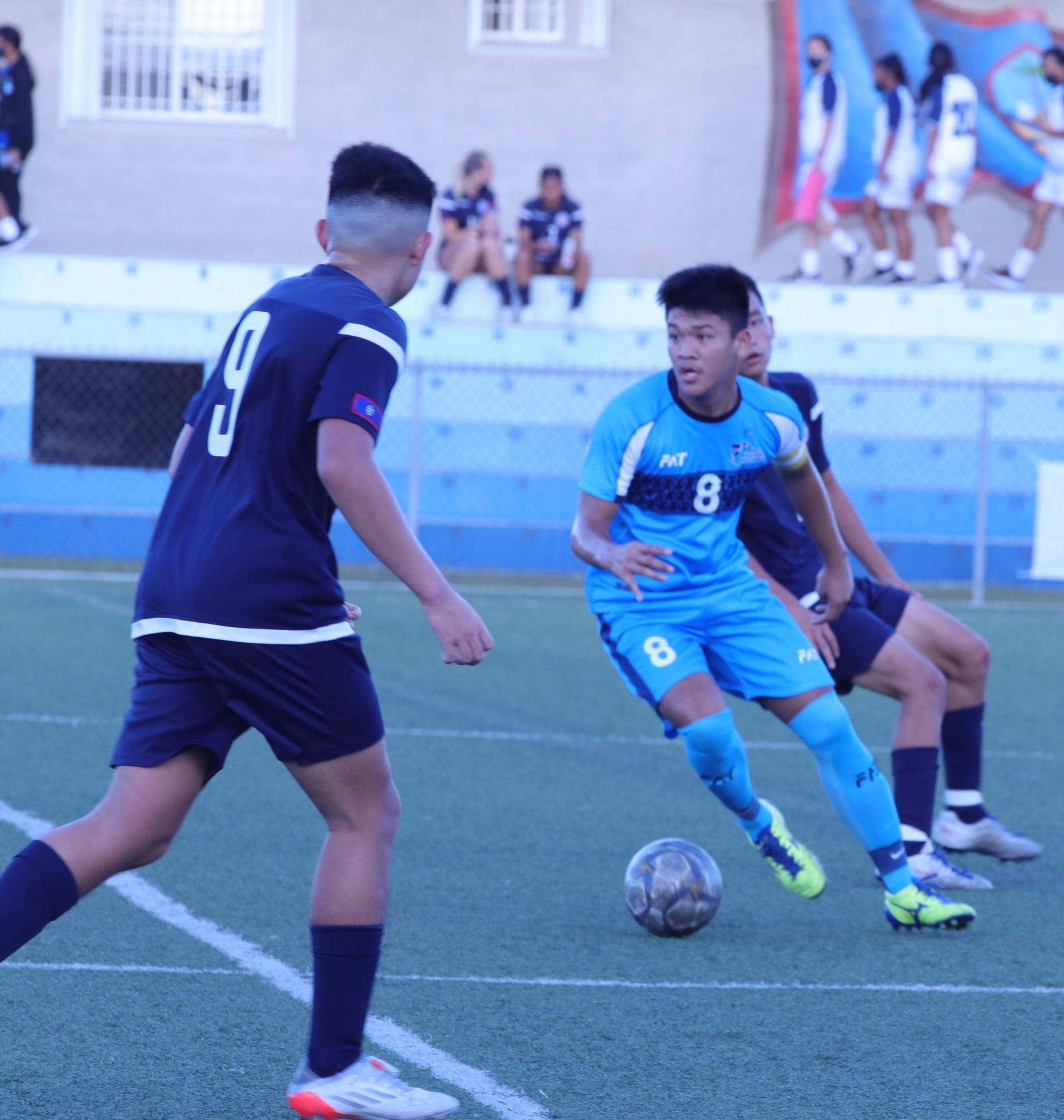 The NMI’s Taka Borja, center, checks on his teammates before making a move during their friendly game against Guam last week at the Guam Football Association National Training Center.