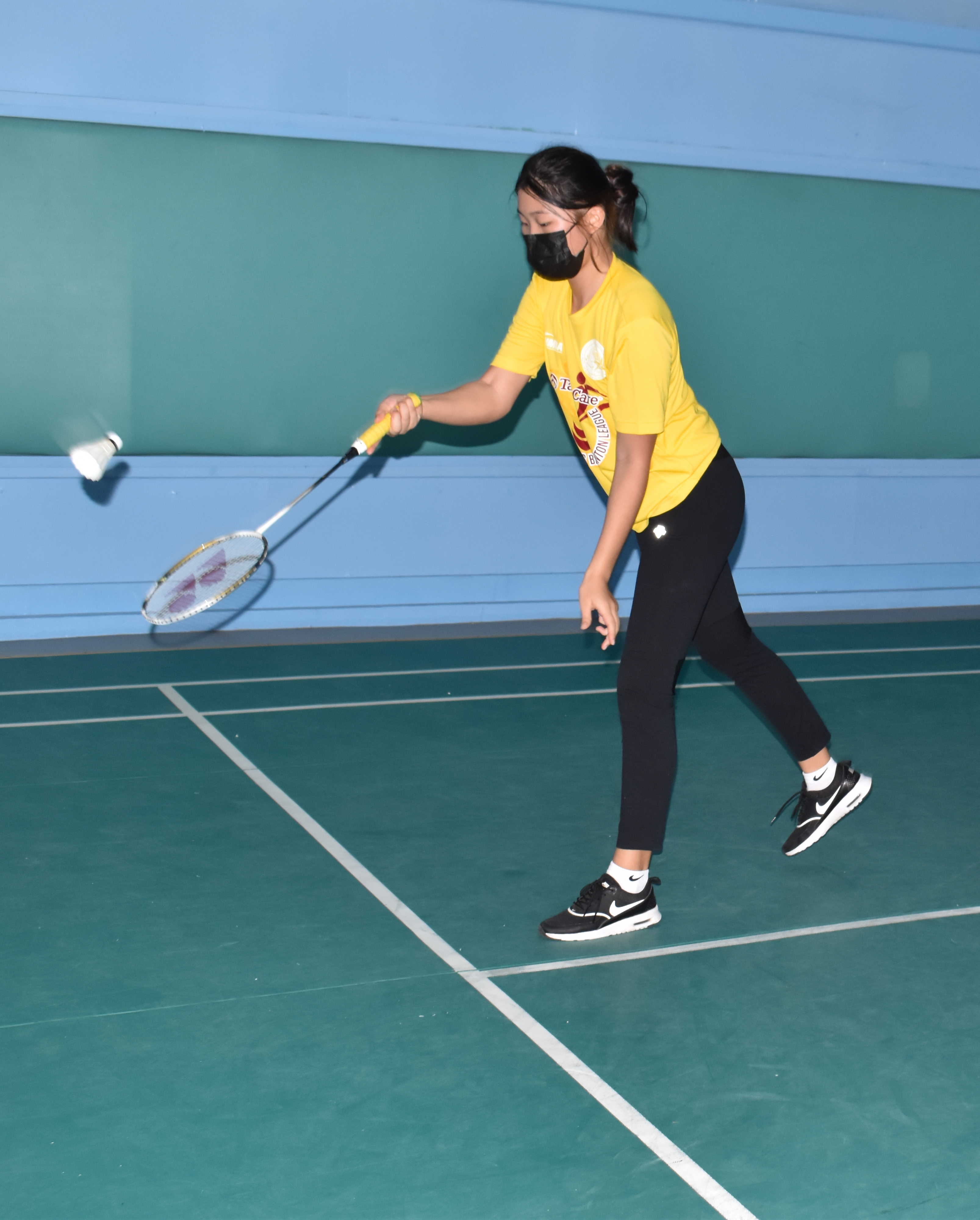 Hopwood 1's Teresa Ahn serves against FMS during a middle school division game of the TakeCare Interscholastic Badminton League  at the TSL Sports Complex.