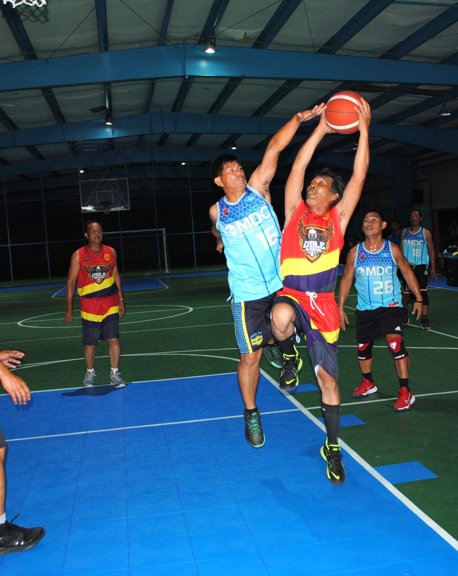 Eagle Construction's Sampang gets fouled as he extends for the shot during a masters division game of the Saipan Centennial Lions Club Basketball League Saturday at the TSL Sports Complex.
