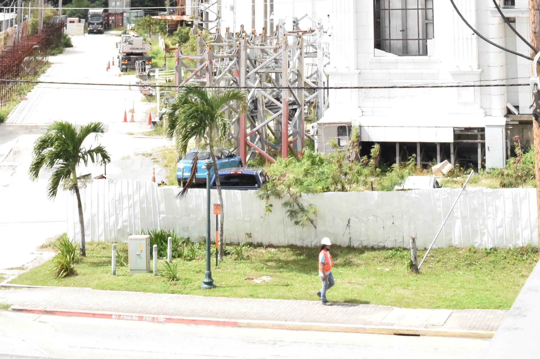 A construction worker leaves the site of the unfinished Imperial Pacific International casino hotel in Garapan earlier this month.