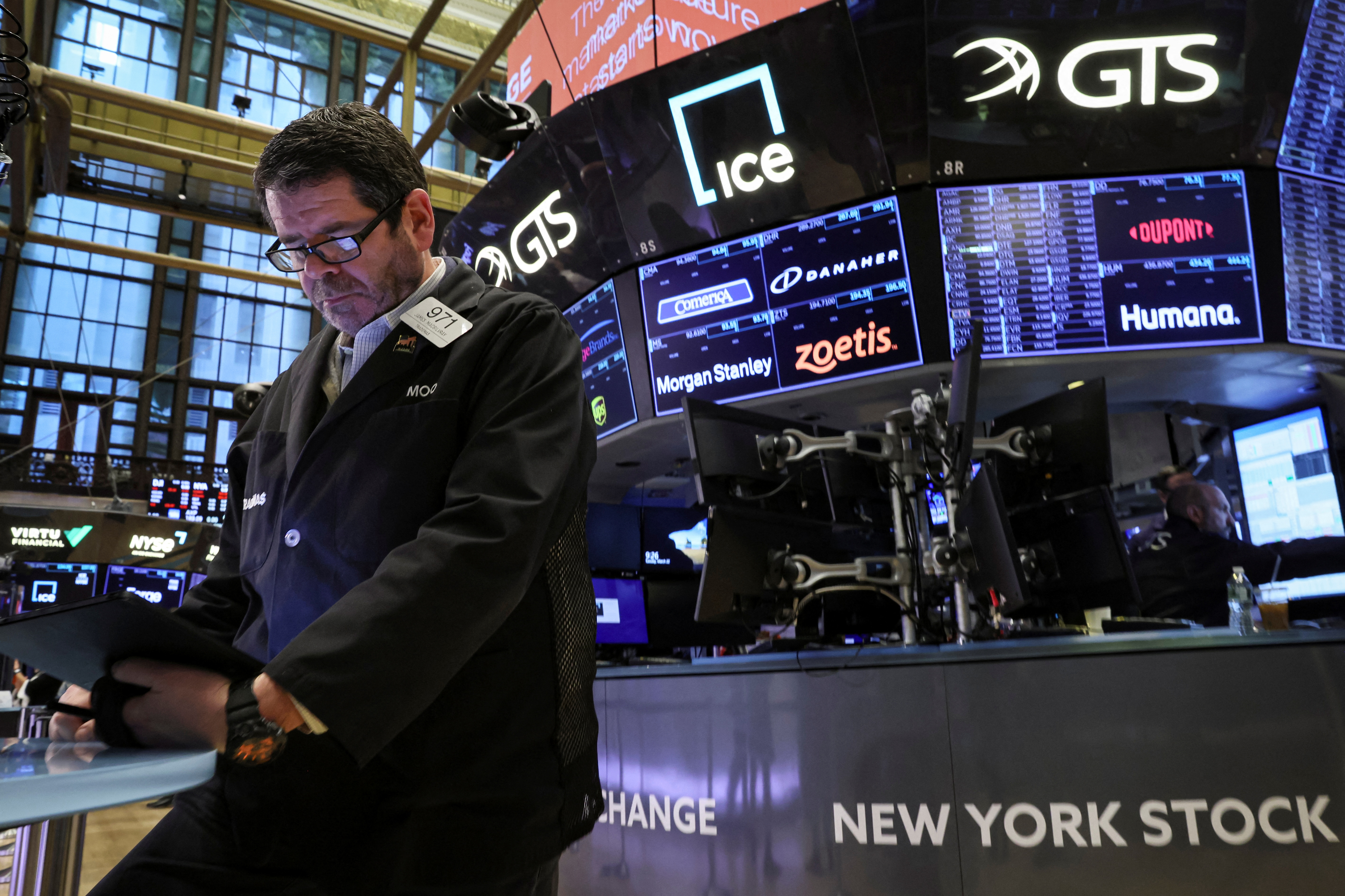 Traders work on the floor of the New York Stock Exchange in New York City, March 22, 2022.