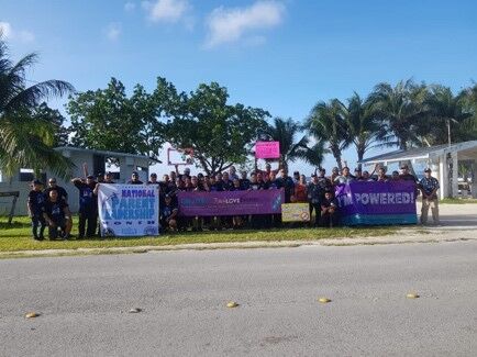 Rota advocates, first responders, and community members take part in a Roadside Waving Against Domestic Violence and Child Abuse in 2019. 