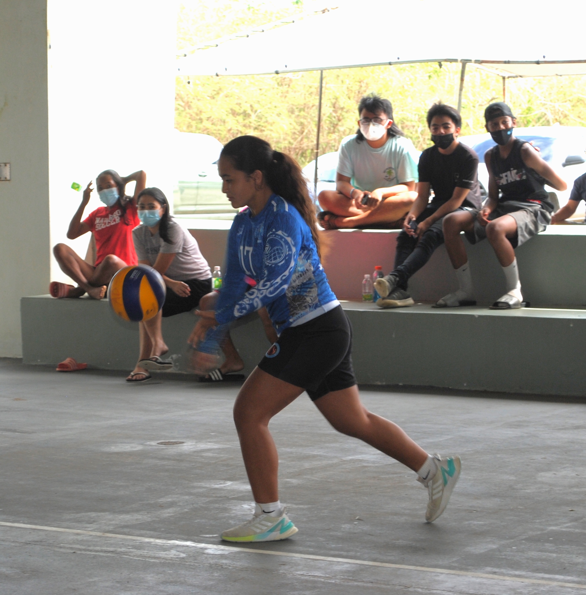 SIS' Phoenix Gross goes for the under hand serve.