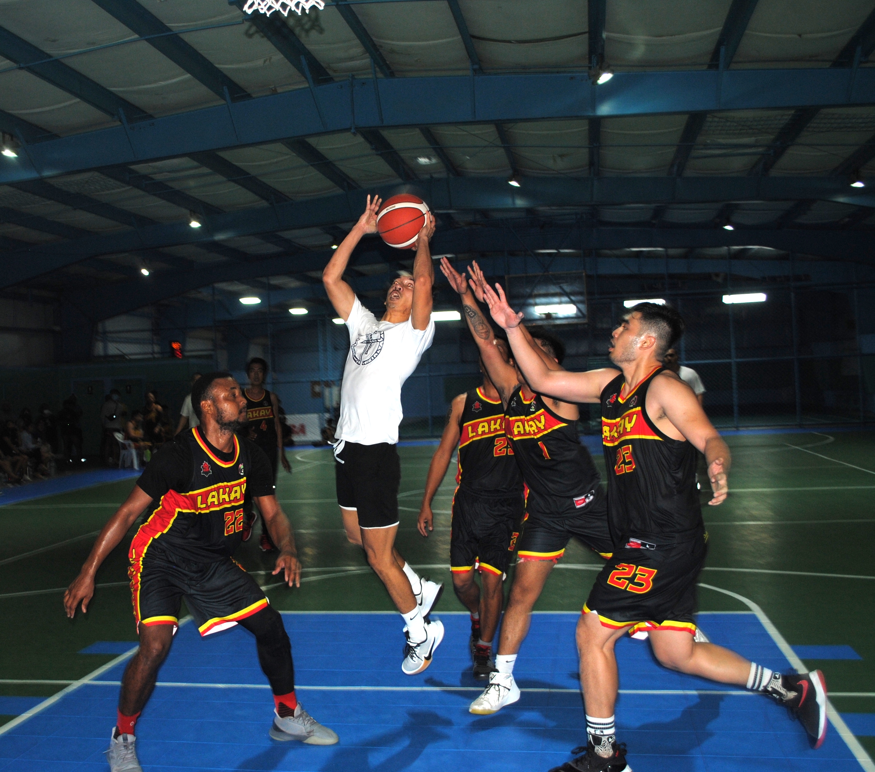 The Game's Mac Mintac gets surrounded by four defenders as he goes up for the shot during a Saipan Centennial Lions Club Basketball League game at the TSL Sports Complex.