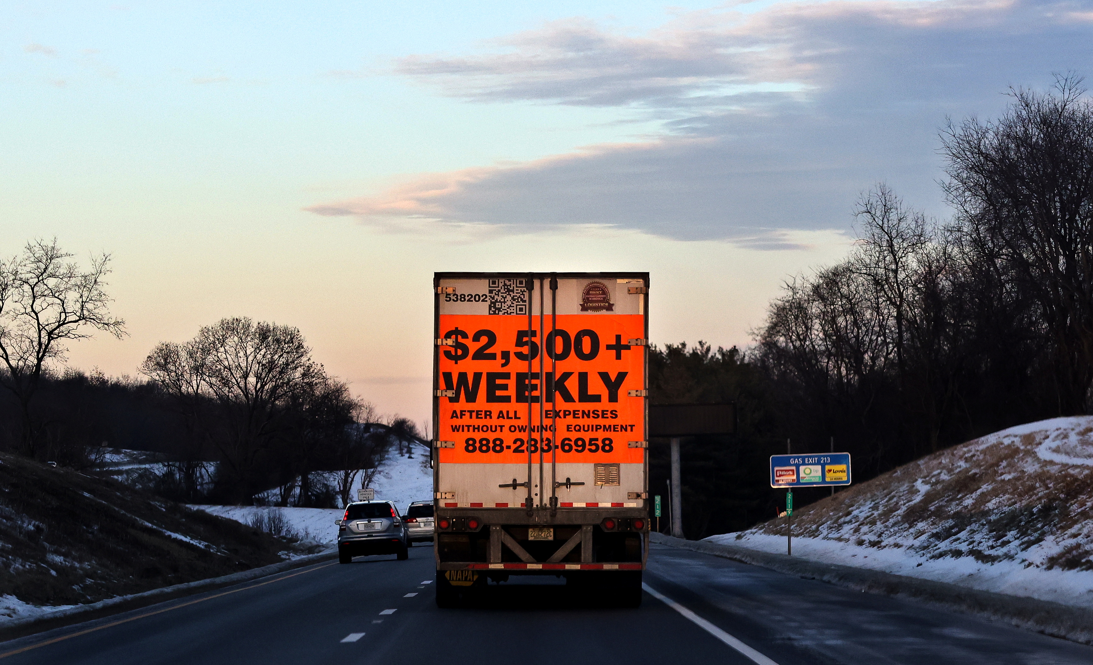 A tractor trailer advertising job opportunities in the trucking industry drives south on Interstate 81 near Staunton, Virginia, Jan. 22, 2022.
