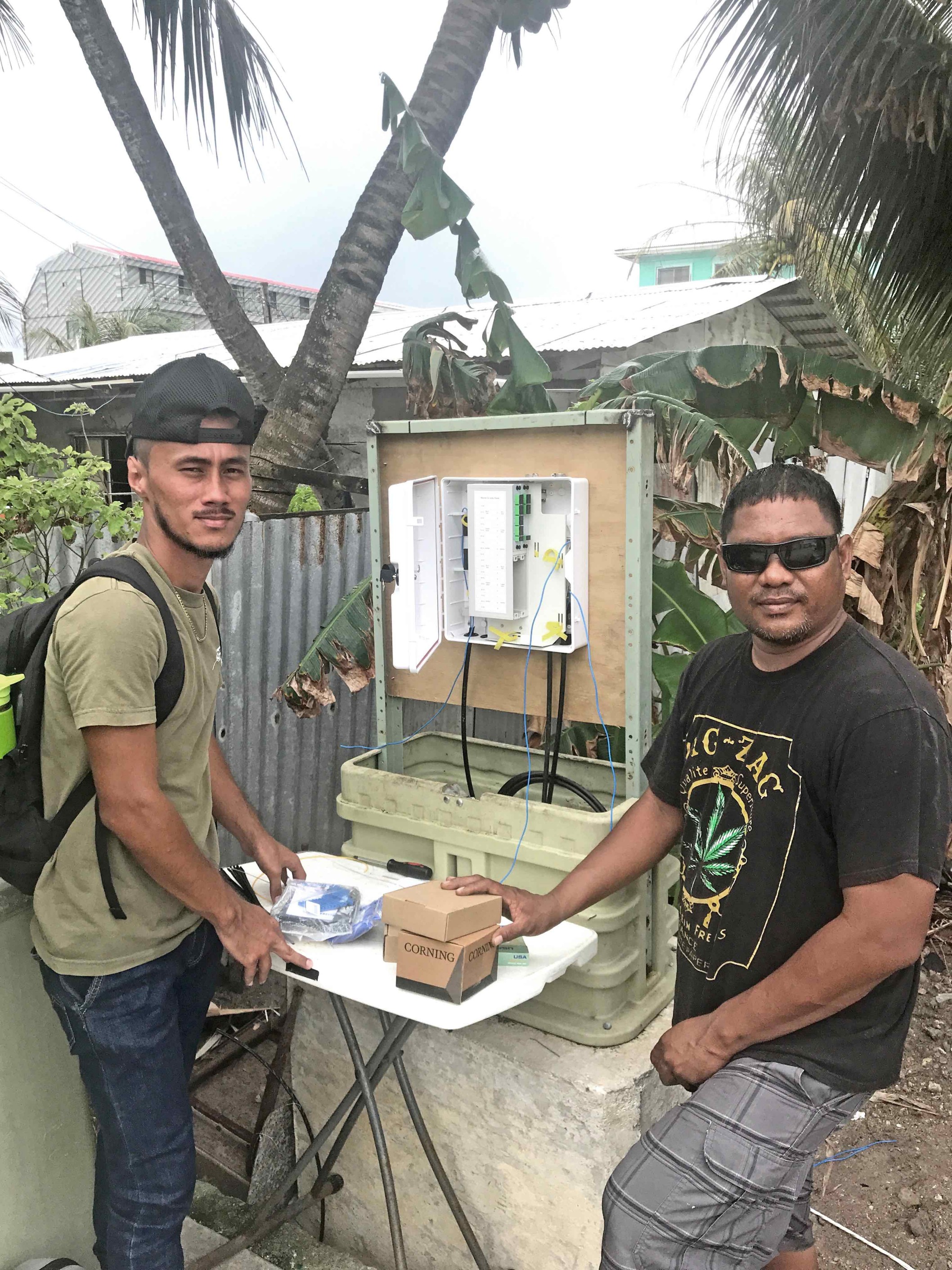 Marshall Islands National Telecommunications Authority IT staff Clayton Jibas, left, and Joshua Bien, install fiber cable to people's homes around Majuro replacing use of telephone copper wires to improve internet service.