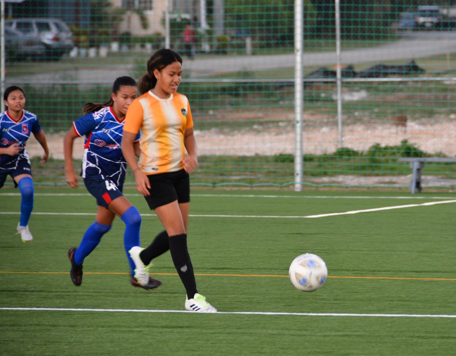 Kanoa’s Alejandra Manabat dribbles past defenders during a U16 girls division game of the TakeCare Youth Soccer League Saturday at the NMI Soccer Training Center.
