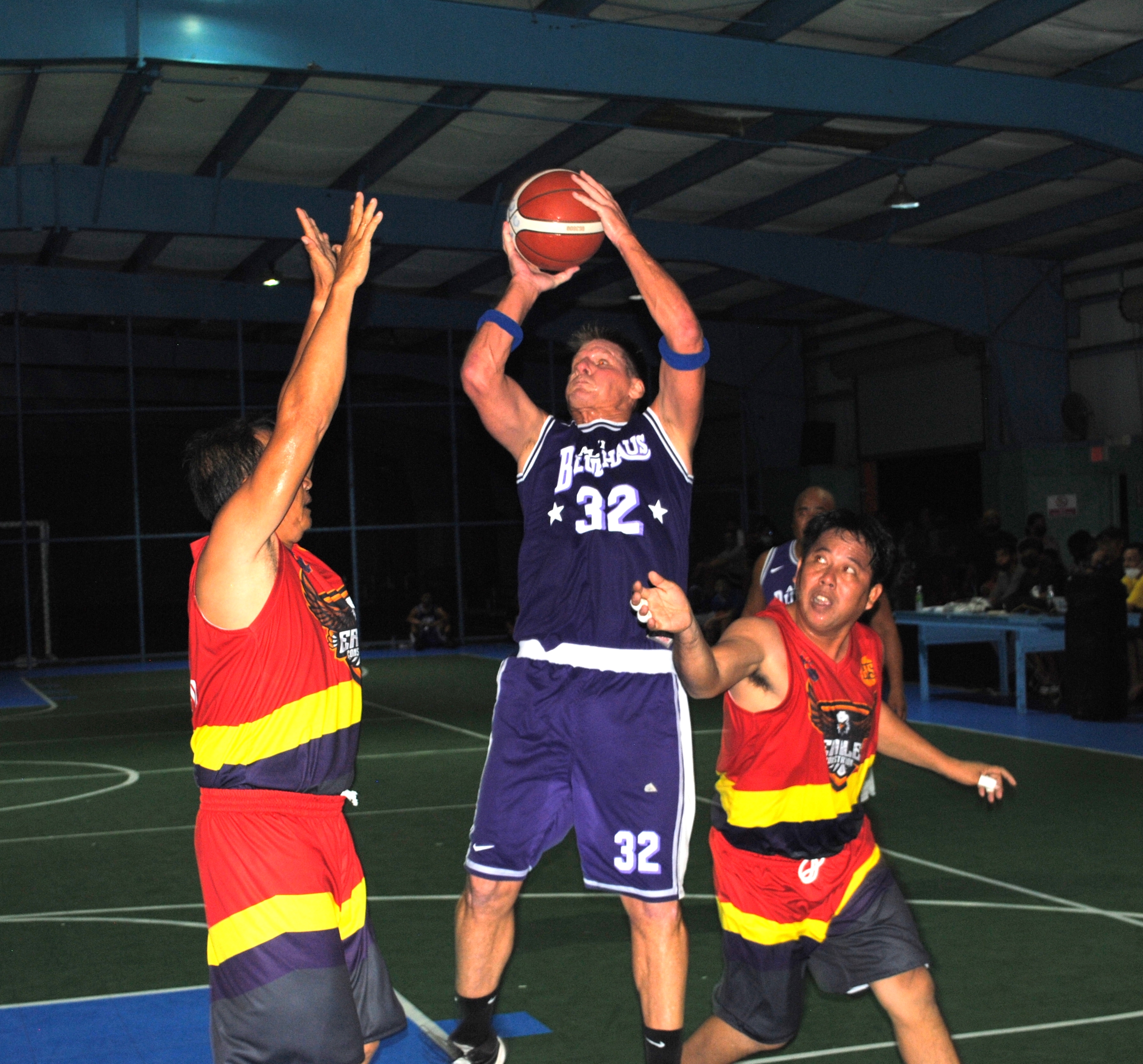 Bluehauz's Berline takes the shot over two defenders during a master's division game of the Saipan Centennial Lions Club Basketball League Saturday at the TSL Sports Complex.