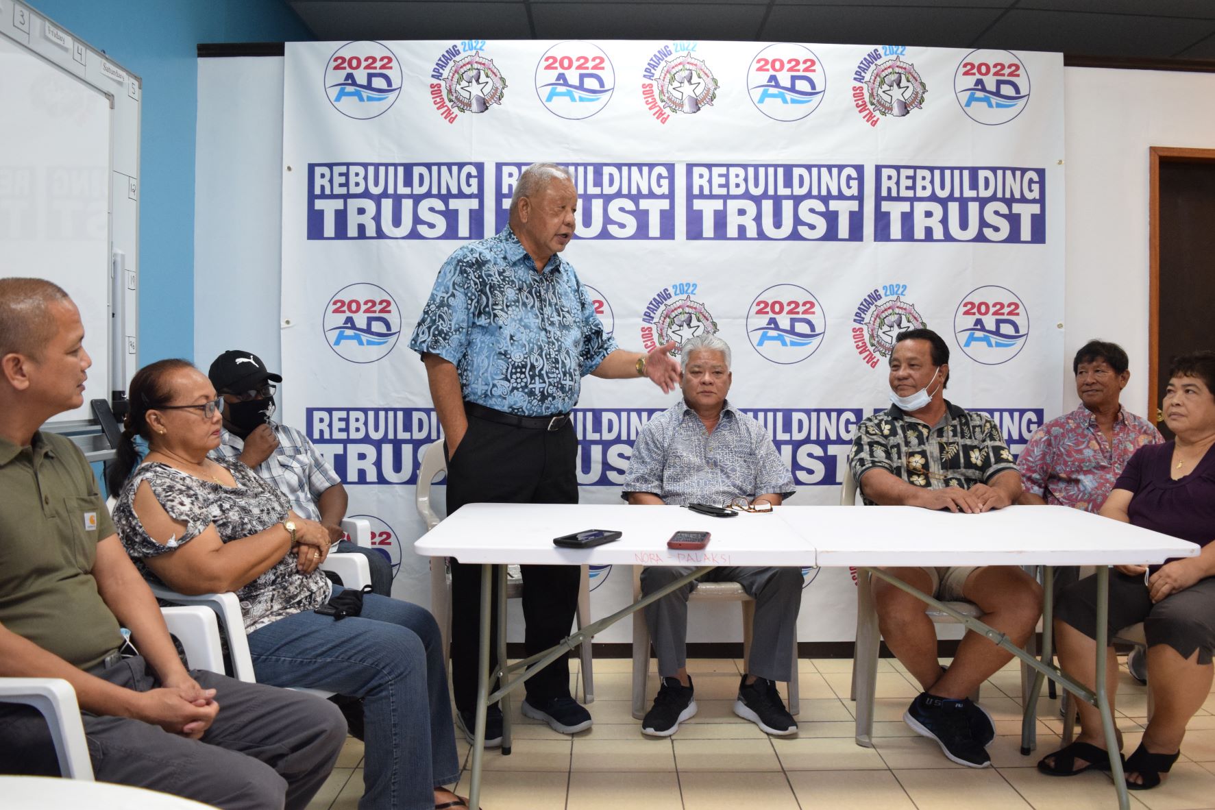 Saipan Mayor David M. Apatang. fourth left, delivers his remarks as  Lt. Gov. Arnold I. Palacios, center, and independent Saipan mayoral candidate Ramon "RB" Blas Camacho listen. Also in photo are Precinct 1 House candidate, retired U.S. Navy sailor Vincent "Kobre" Seman Aldan, left, Shawn DLR Kaipat, third left, his mother, Maggie, second left, RB for Mayor campaign committee chairman, Ray B. Aldan, second right, and RB Camacho's wife, Delia, at the AD 2022 headquarters in Garapan on Friday. Palacios and running-mate Apatang are running for governor and lt. governor as independent candidates.