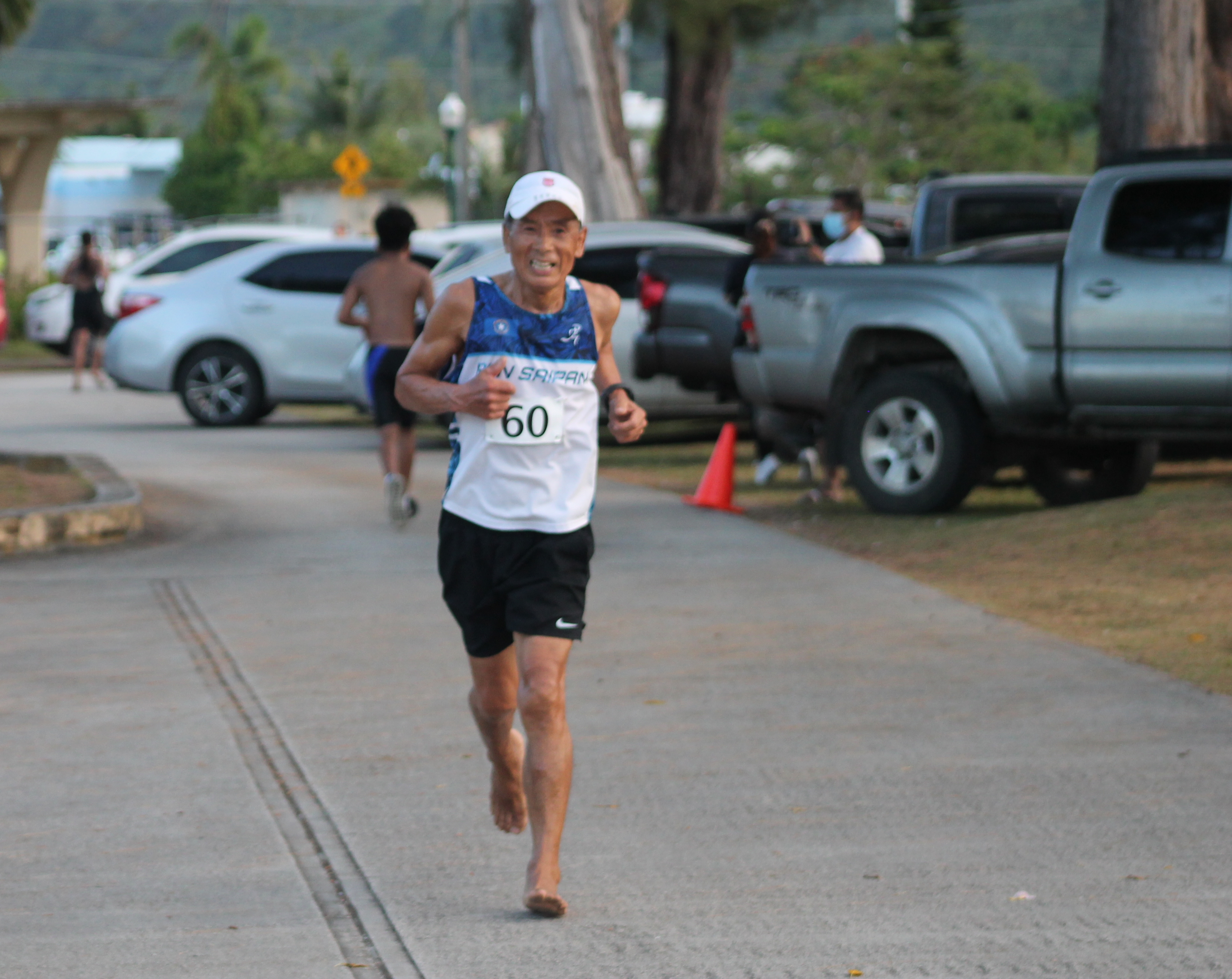 Jang Changwan smiles as he reaches the finish line of the 10km Pathway run. 