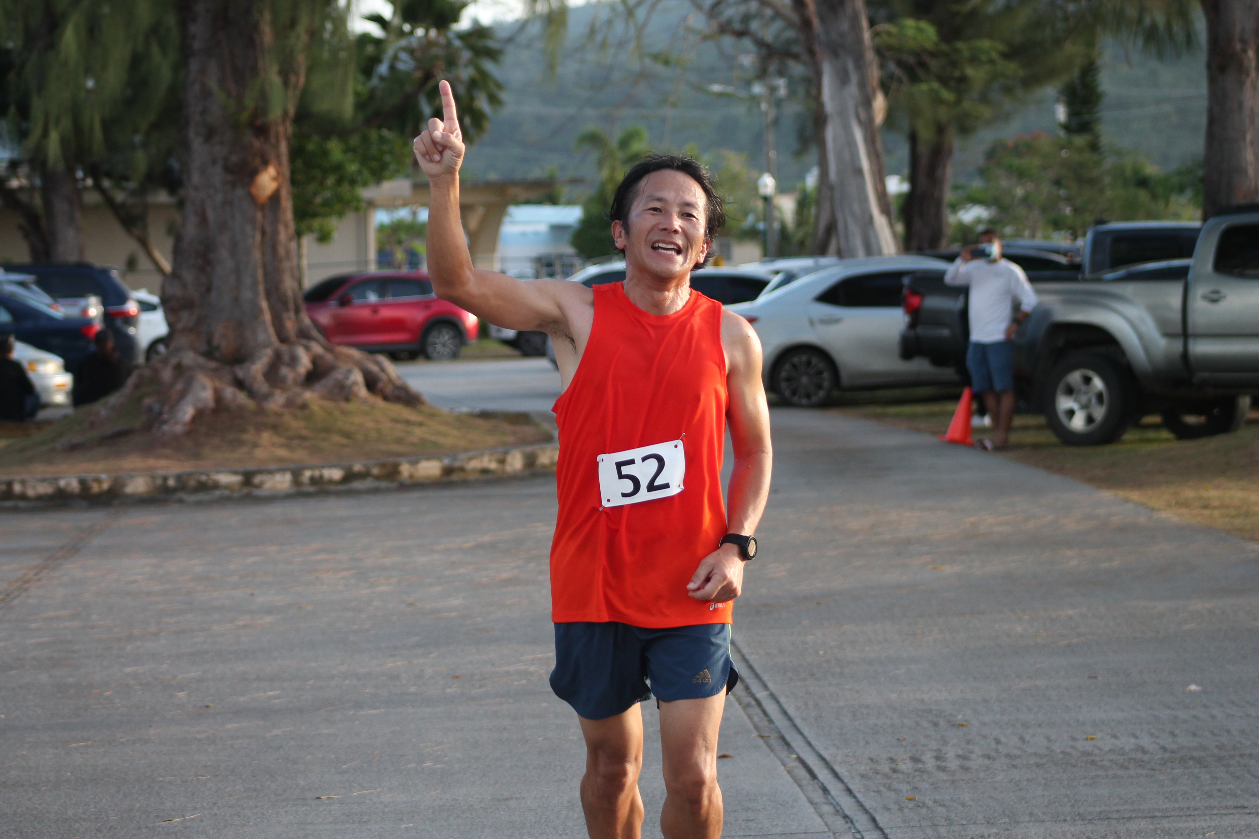 Kosuke Sato celebrates as he finishes first in the male division of the 10km pathway event hosted by the Triathlon Association of the CNMI  Saturday at the Kilili Pavilion.