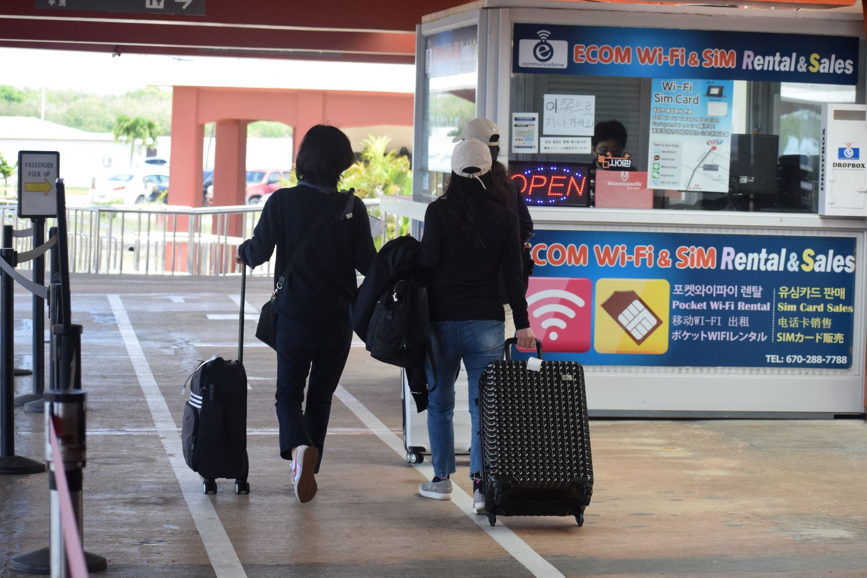 Newly arrived visitors from South Korea walk toward the passenger pick-up area of the Francisco C. Ada/Saipan International Airport on Wednesday.