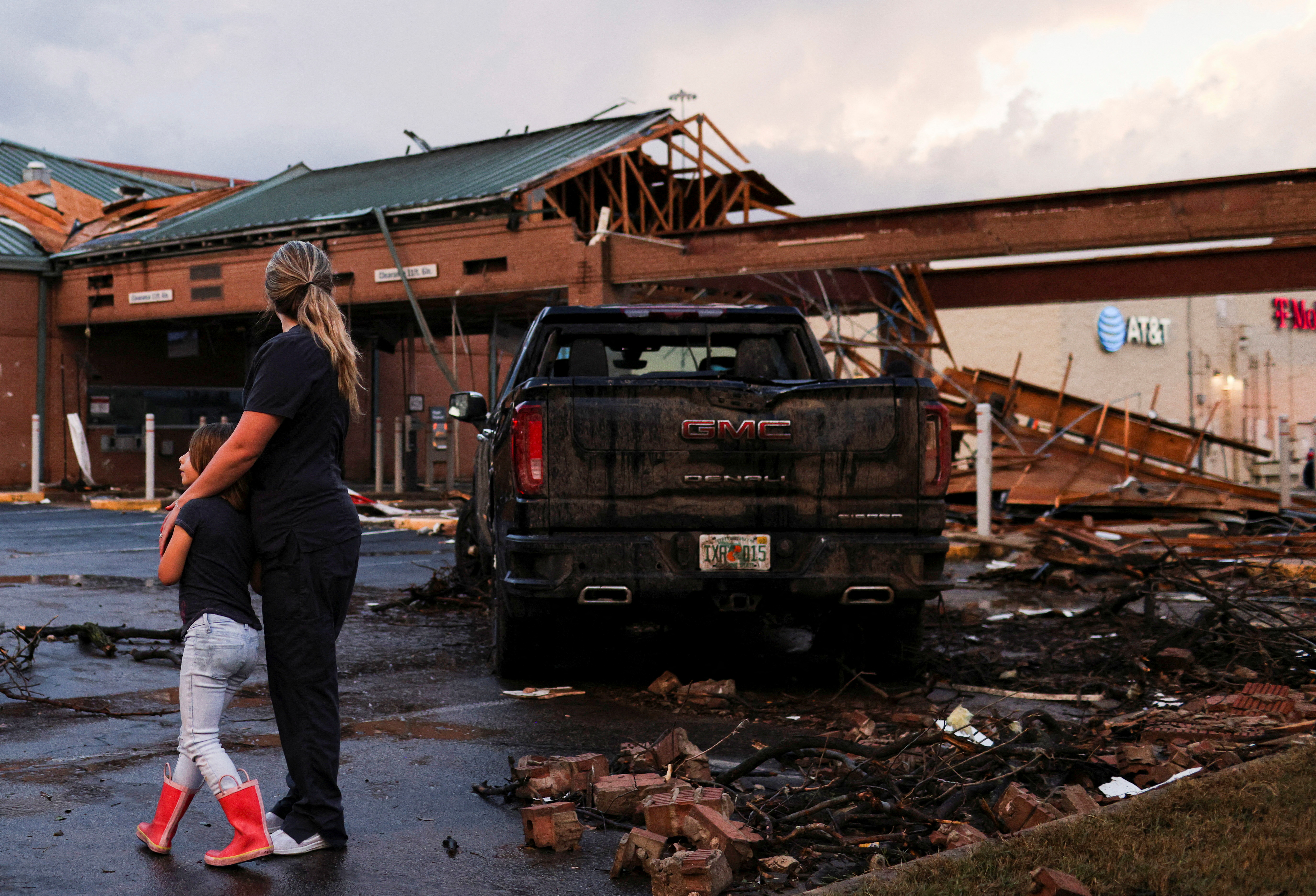 People survey the damage to a shopping center after a tornado in a widespread storm system touched down in Round Rock, Texas, March 21, 2022.