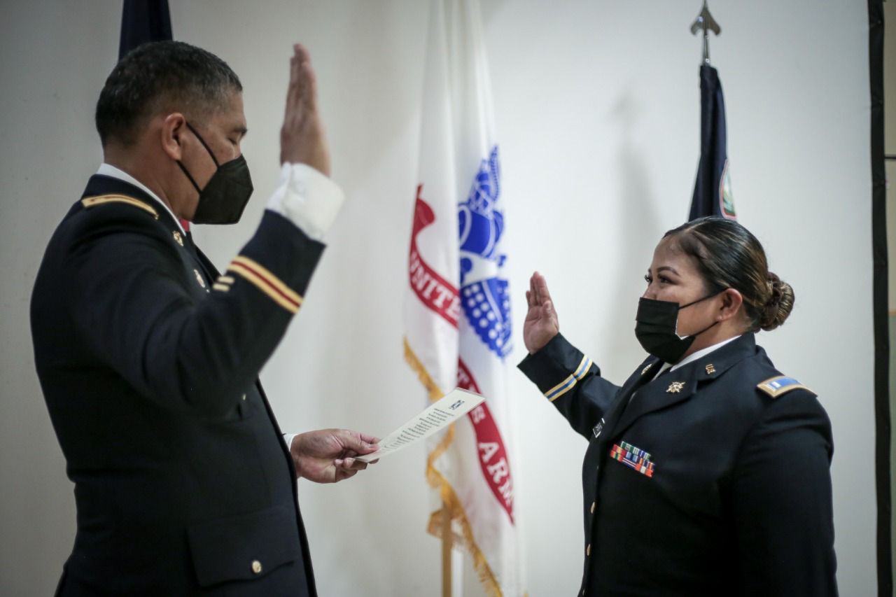 Maj. Juan King, acting commander of the Guam Army National Guard, administers the oath of office to Capt. Jemilyn A. Sakisat at the Guam Army National Guard Readiness Complex in Barrigada, Guam on March 6, 2022.