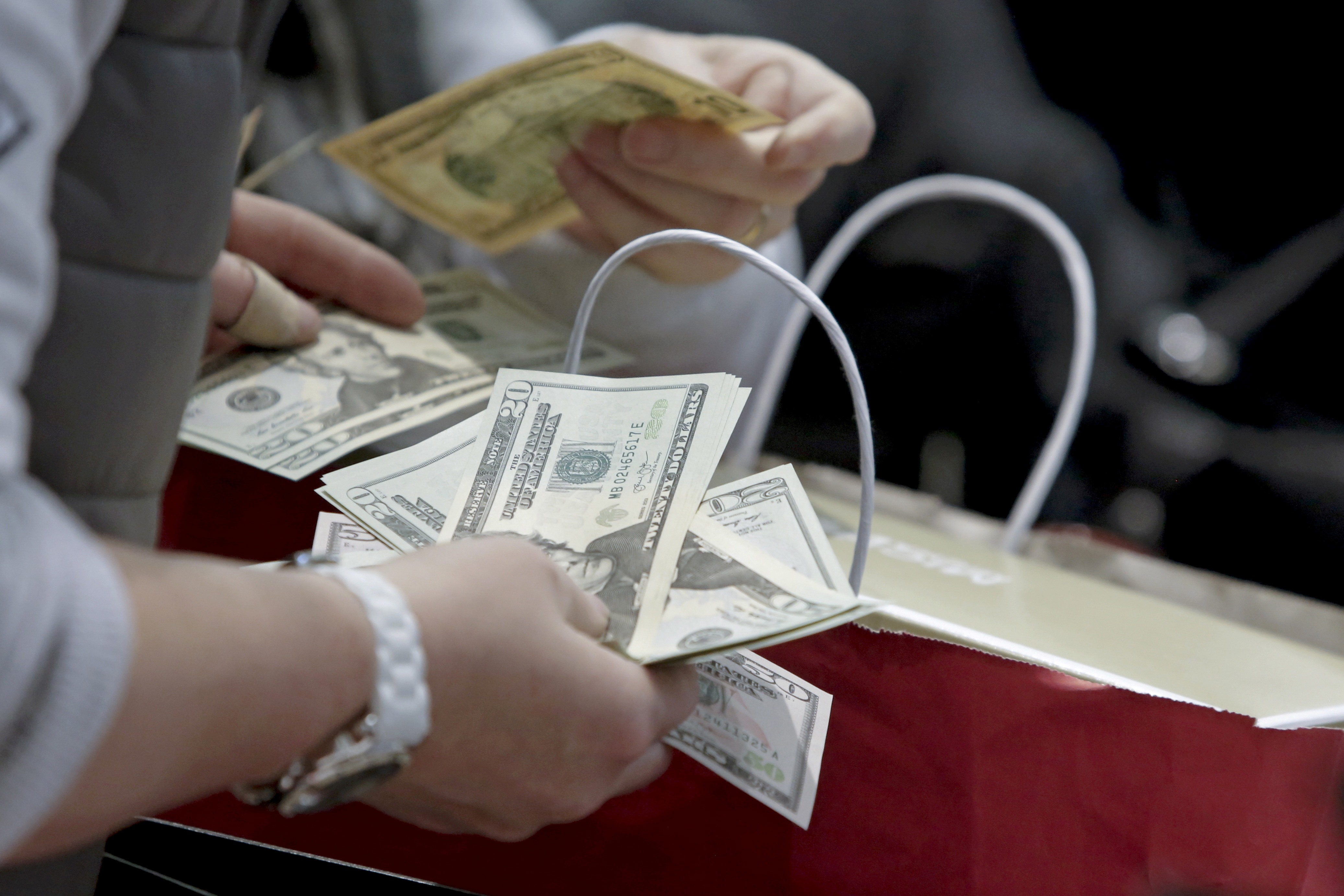 People count money at Macy's Herald Square store during the early opening of the Black Friday sales in the Manhattan borough of New York, Nov. 26, 2015.