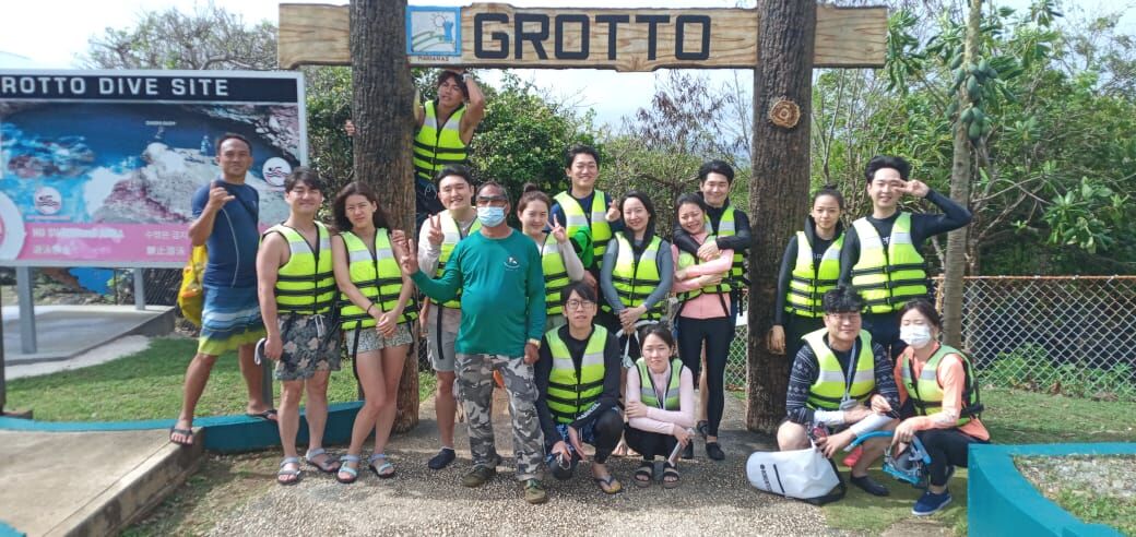 Community volunteer Max Aguon poses with Korean tourists at the Grotto in Marpi.  Ralph Alvarado of Saipan Adventure says it’s great to see Aguon in the area. “The tourist site is always nice, clean, and safe for visitors,” Alvarado says.