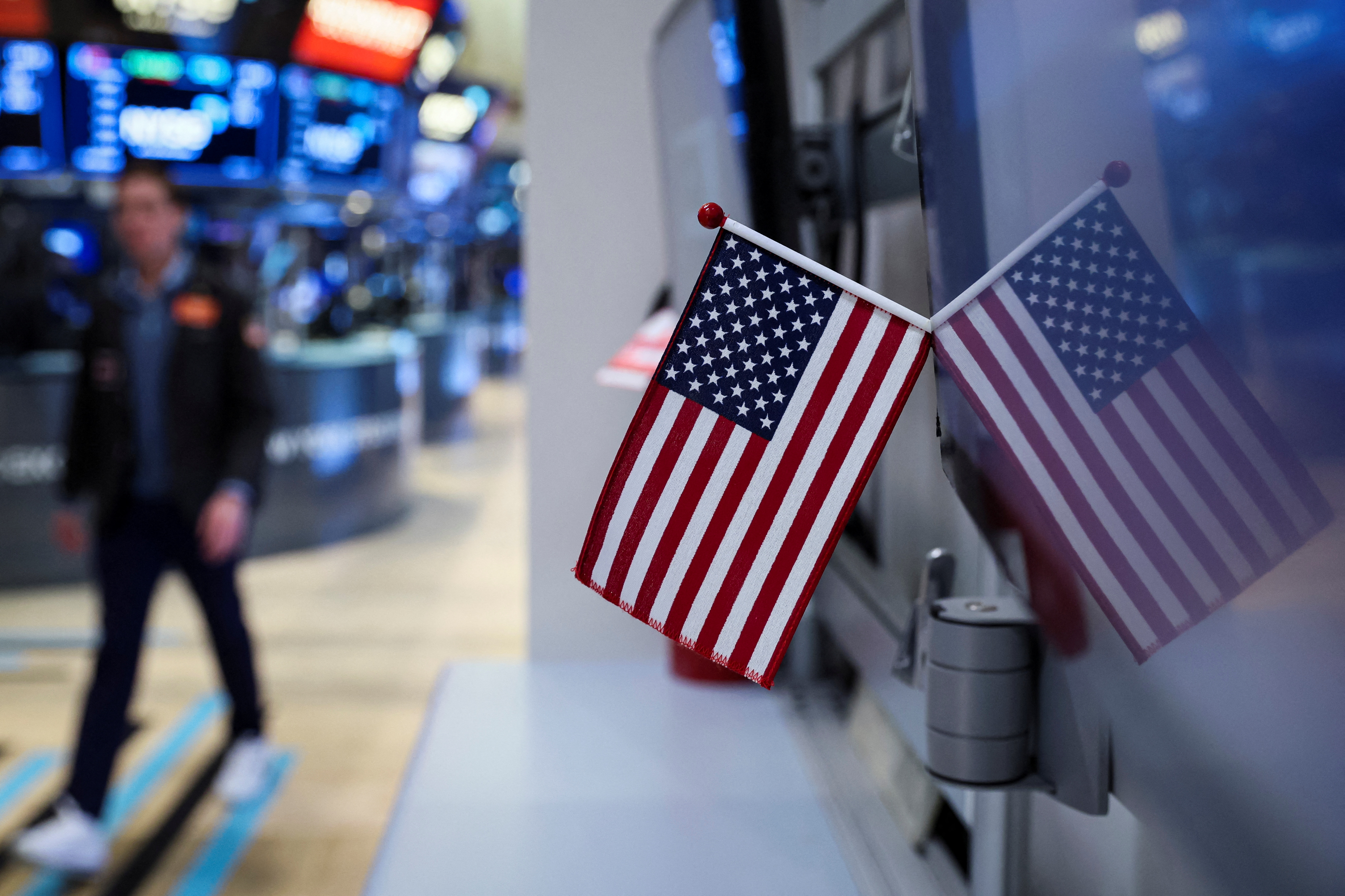 View of the U.S. flag as a trader works on the floor of the New York Stock Exchange in New York City, March 21, 2022.