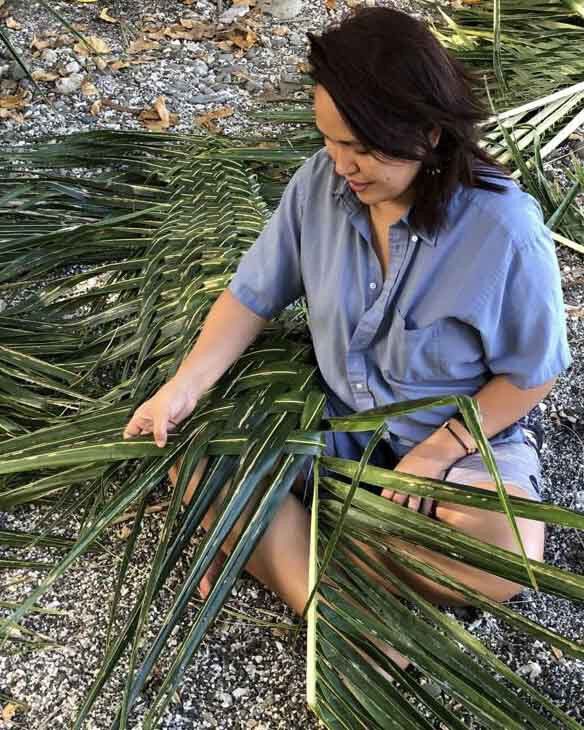 Nicole Duenas weaves during a Traditional Seafaring Navigation class taught by Larry Raigetal.