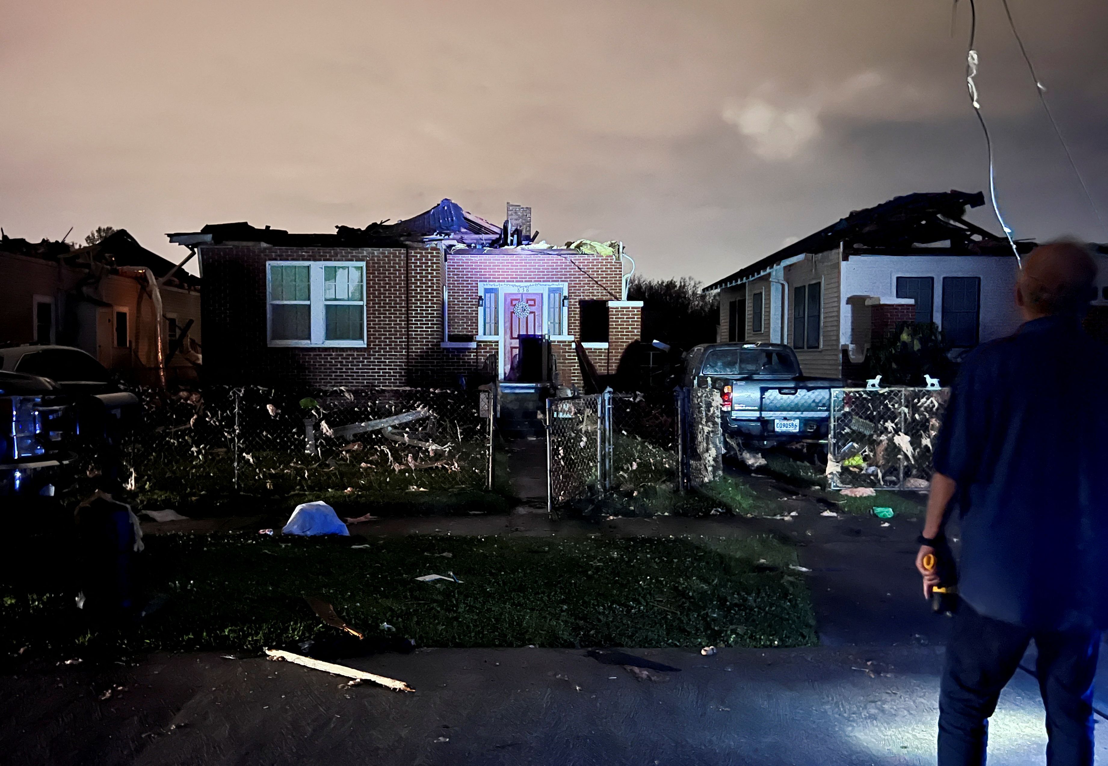 A car lies overturned among debris in the Arabi neighborhood after a large tornado struck New Orleans, Louisiana, March 22, 2022.