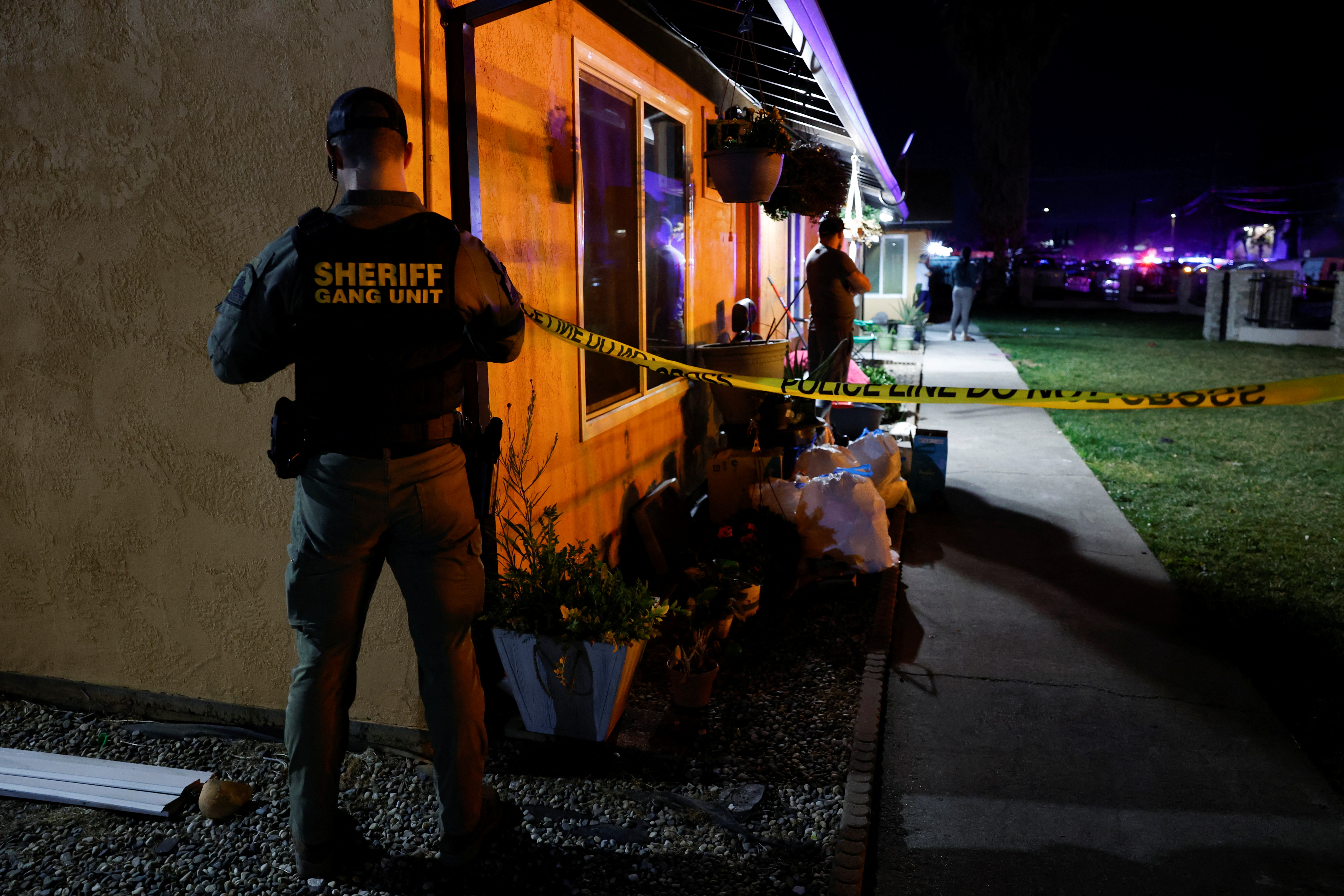 A sheriff's deputy puts up crime scene tape following a shooting at a church in Sacramento, California, Feb. 28, 2022.