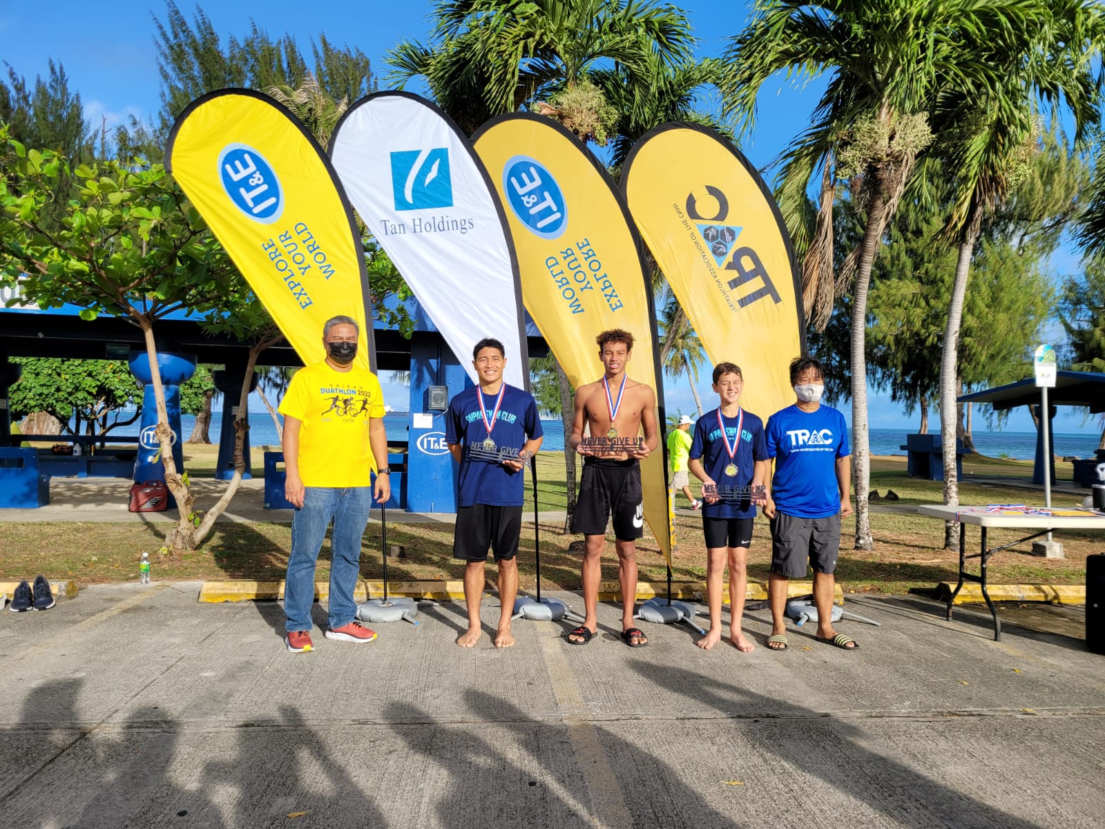 7th Aquathon men winners Jakey Deleon Guerrero, Isaiah Aleksenko and Michael Miller with Triathlon Association of the CNMI officials. 