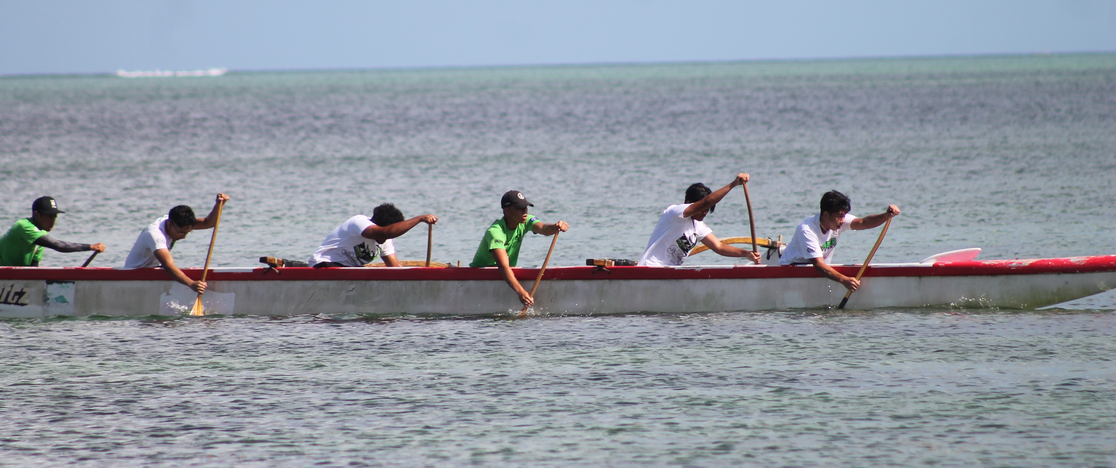 The Saipan Southern High School men's team members head to the finish line during the opening race of the PSS Co-ed Outrigger on Saturday at Kilili Beach.
