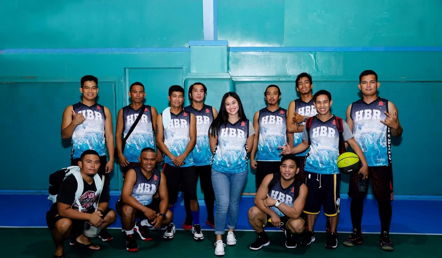 HBR team members  pose with their muse during the opening ceremony of the Saipan Centennial Lions Club Basketball League on Feb. 19, 2022 at the TSL Sports Complex.