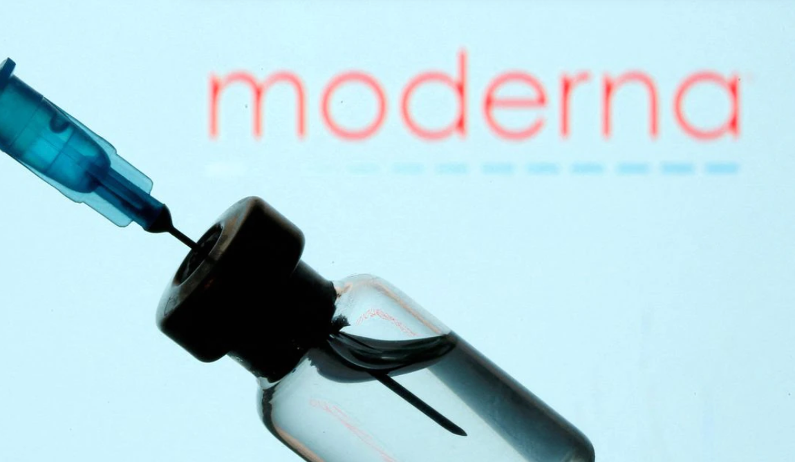 A vial and syringe are seen in front of a displayed Moderna logo in this illustration taken on Jan. 11, 2021.